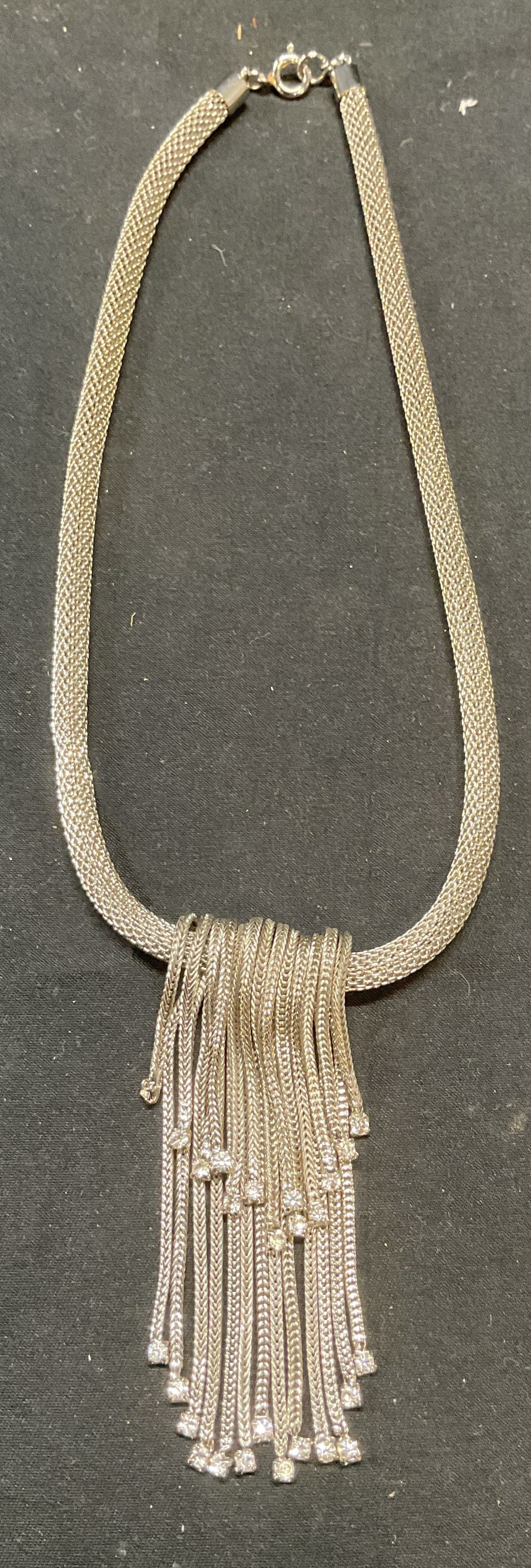 Silver Tone Crystal Pendant Necklace: Silver tone mesh chain pendant necklace with chain and colorless crystal decoration. Drop length approx. 7 inches. Pendant length approx. 2.5 inches. Some surface wear including scratching observed. J