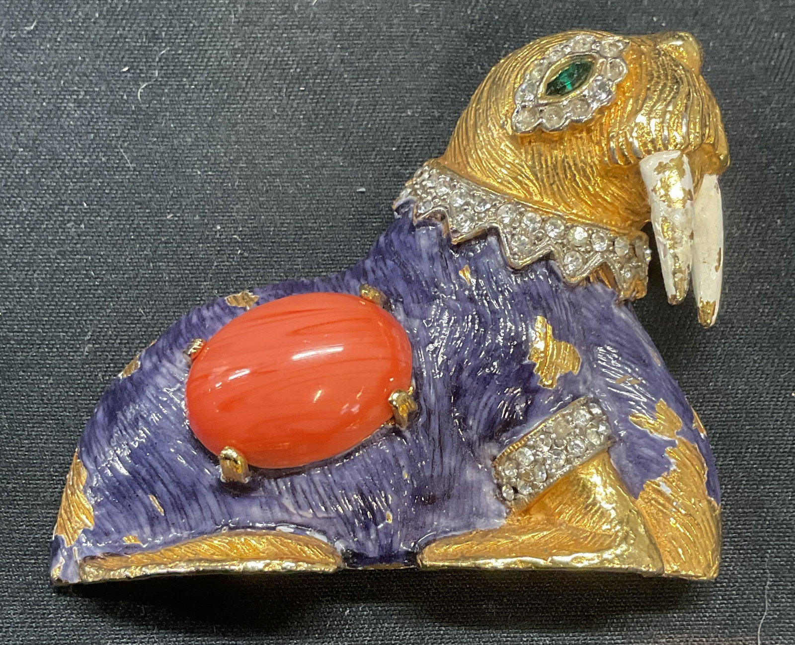Vintage Kenneth Lane Crystal Walrus Brooch: Vintage Kenneth Lane gilt walrus motif brooch with enamel, coral cabochon, and crystal decoration. Signed KJL to underside. Hinge pin to underside. Measures approx. 2 x 1.75 inches. Some surface wear 