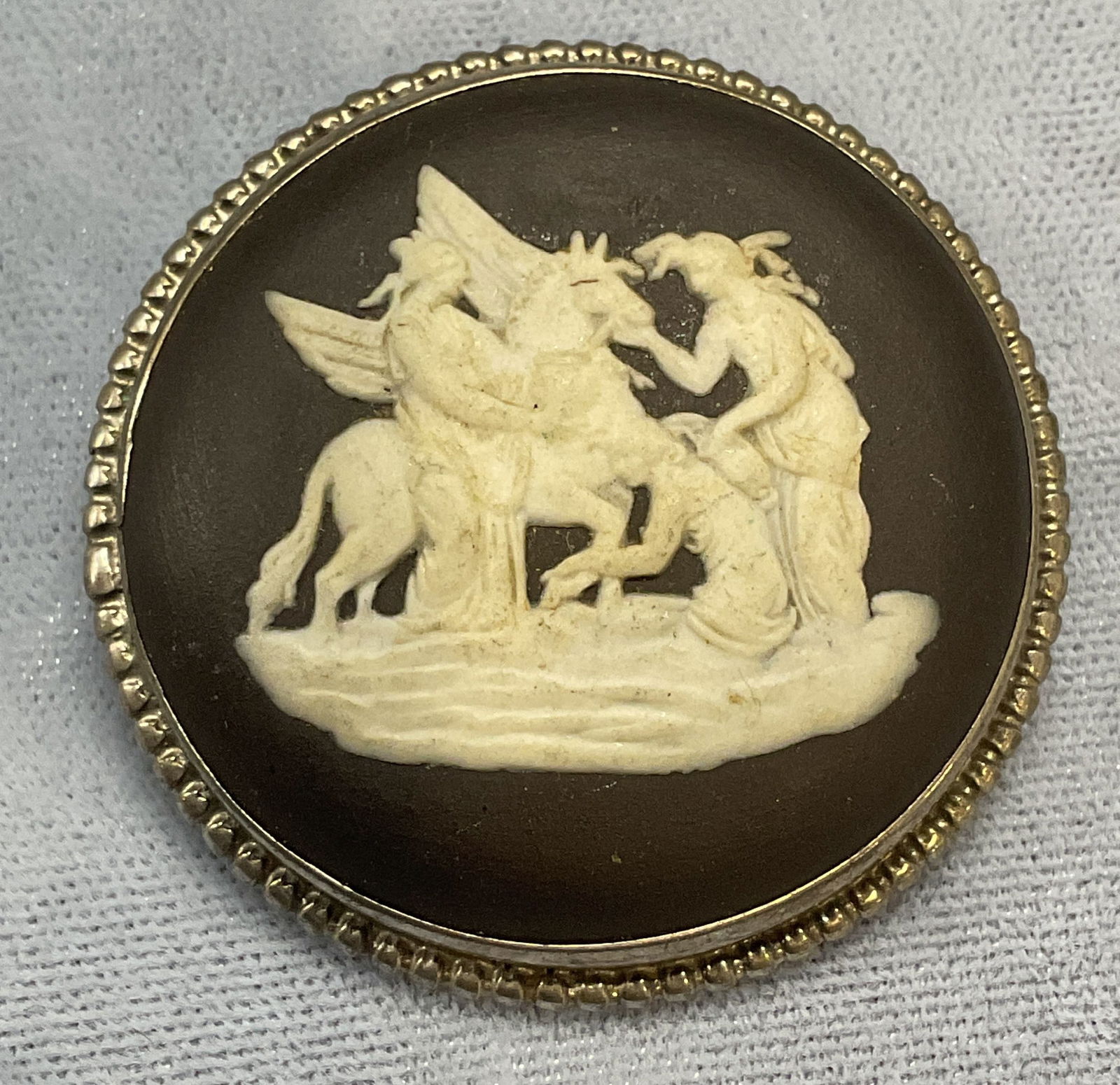 Vntg Wedgwood Jasperware Sterling Silver Brooch: Vintage Wedgwood black Jasperware brooch with sterling silver setting. White has relief Grecian motif. Signed to underside. Made in England. Tests for sterling using PuriTEST kit. Measures approx. 1.5