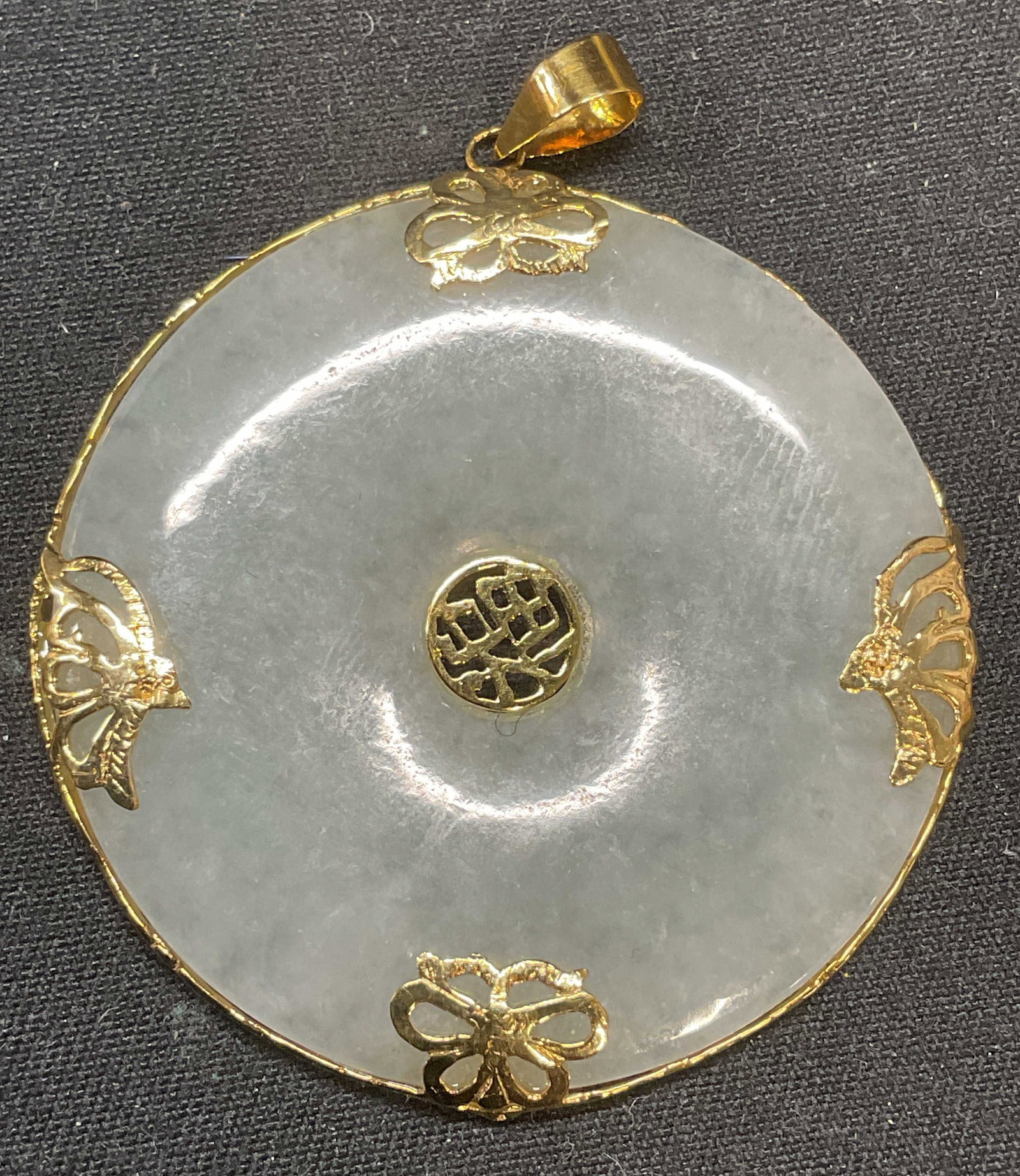 14K Gold & Jadeite Longevity Pendant: Chinese longevity pendant. Carved and polished semi precious stone, possibly jadeite, and 14k gold setting. Butterfly motif and Chinese characters on settings. Marked 14k/585 on loop. Measures approx.