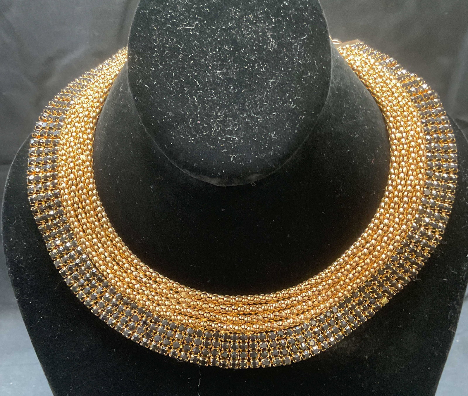 Gold Tone Black Crystal Choker Necklace: Gold tone multi chain choker necklace with black crystal decoration. Measures approx. 4.75 inches wide. Some surface wear including scratching observed. Small area of separation between chains observe