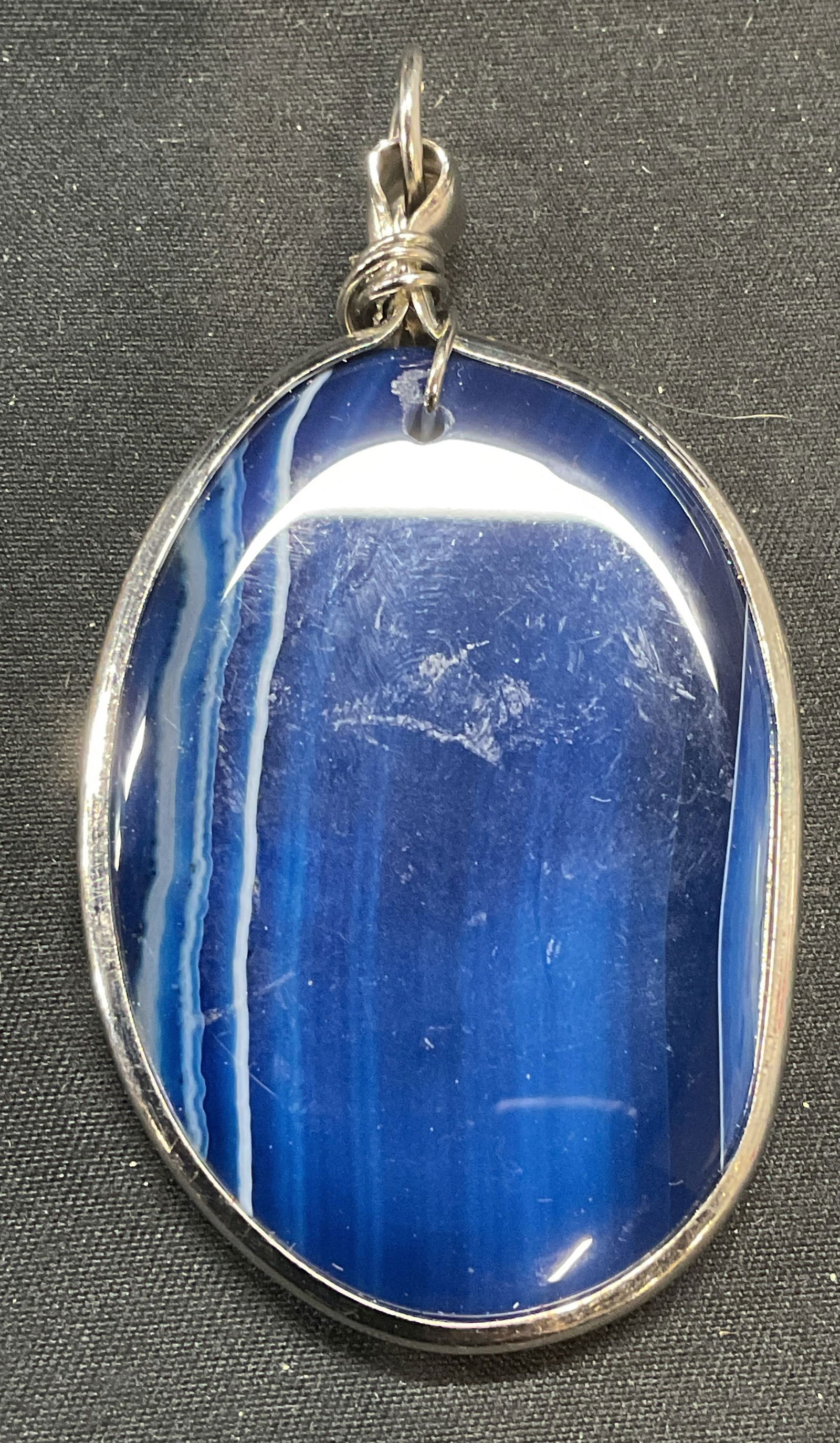 Silver Tone Blue Agate Pendant: Blue agate pendant in silver tone metal setting. Measures approx. 2 x 1.5 inches. Some surface wear including scratching observed. Jewelry, estate jewelry, costume jewelry, cocktail jewelry, fashion j