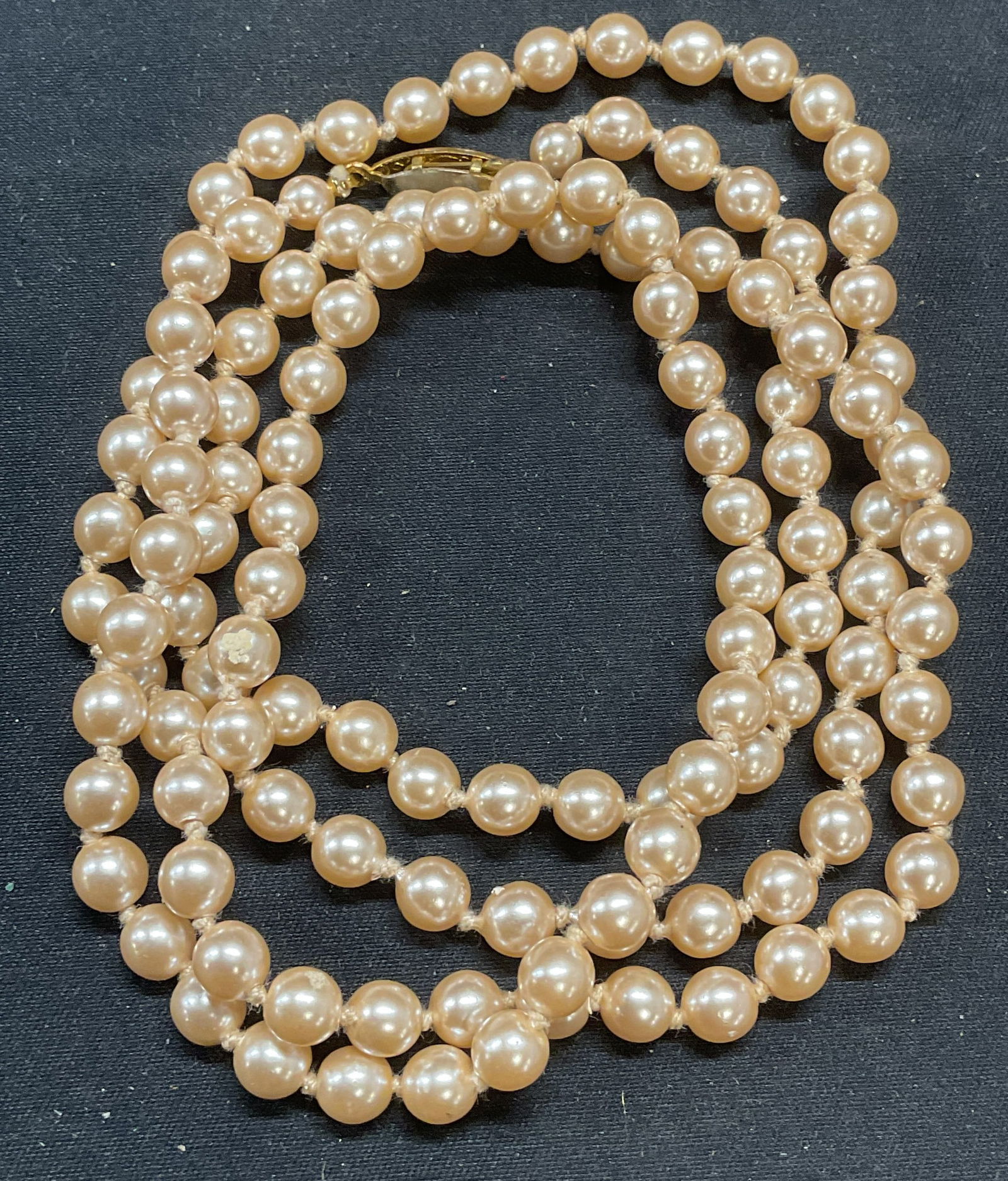Vintage Faux Champagne Pearl Necklace: Vintage faux champagne pearl beaded necklace on drop knotted string. Drop length approx. 18 inches. Some surface wear including scratching observed. Jewelry, estate jewelry, costume jewelry, cocktail