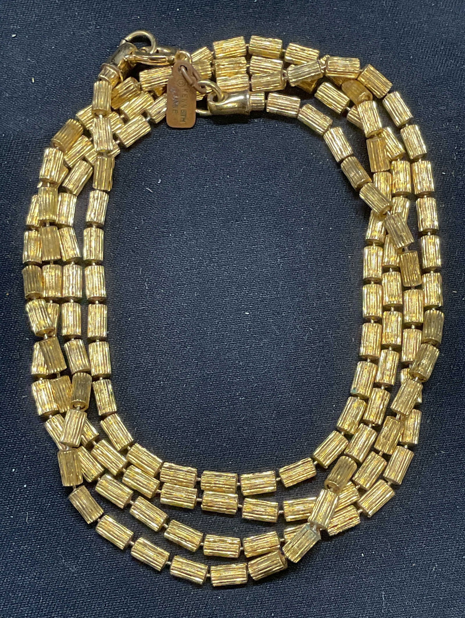 Vintage Kenneth Lane Gold Tone Necklace: Vintage Kenneth Lane gold tone beaded necklace. Signed on hang tag. Drop length approx. 17.5 inches. Some surface wear including scratching observed. Jewelry, estate jewelry, costume jewelry, cocktail