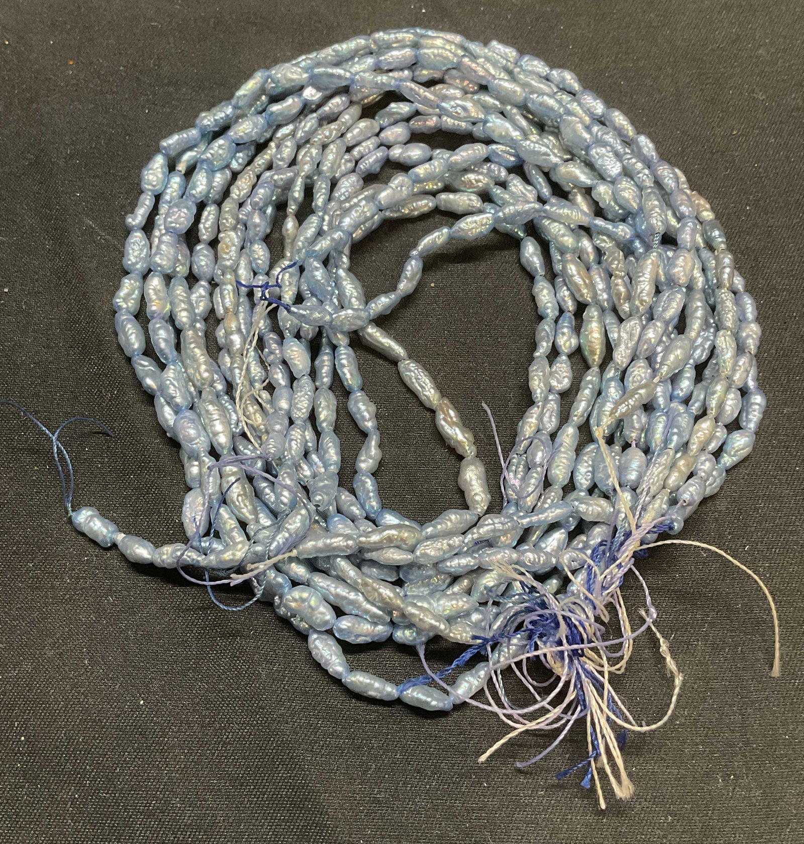 Lot 8 Natural Blue Tone Baroque Seed Pearl Strands: Lot of 8 strands of natural baroque seed pearls on string. Blue toned, possibly dyed. For jewelry making or crafting. Lengths vary, longest strand approx. 16.25 inches long. Some surface wear includin