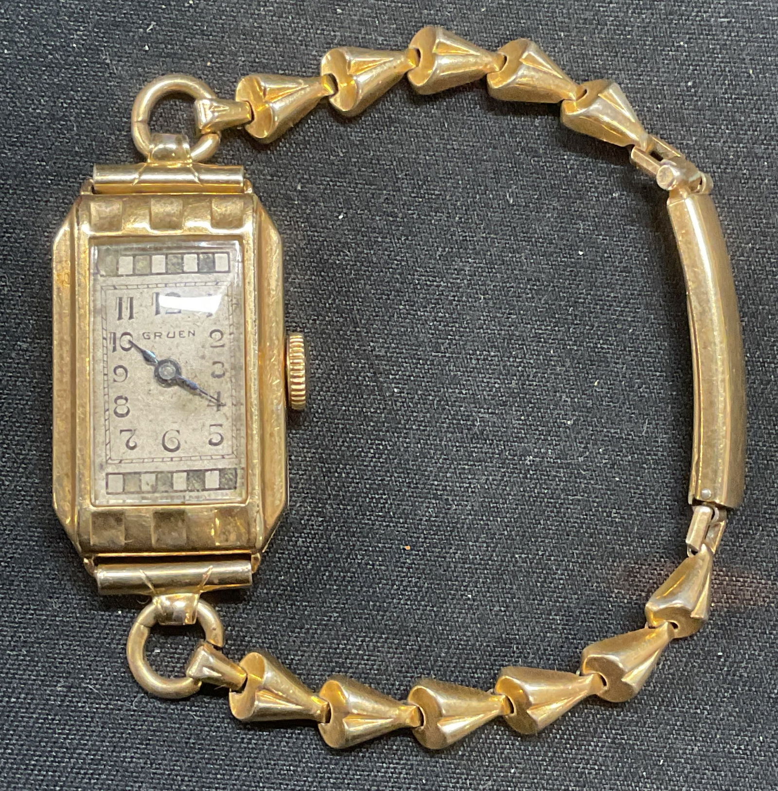 Vintage Gruen 12k Gold Filled Wrist Watch: Vintage Gruen 12k gold filled wrist watch with bracelet strap. Signed on dial. Measures approx. 1.75 inches wide. Not tested for function. Some surface wear including scratching observed. Jewelry, est