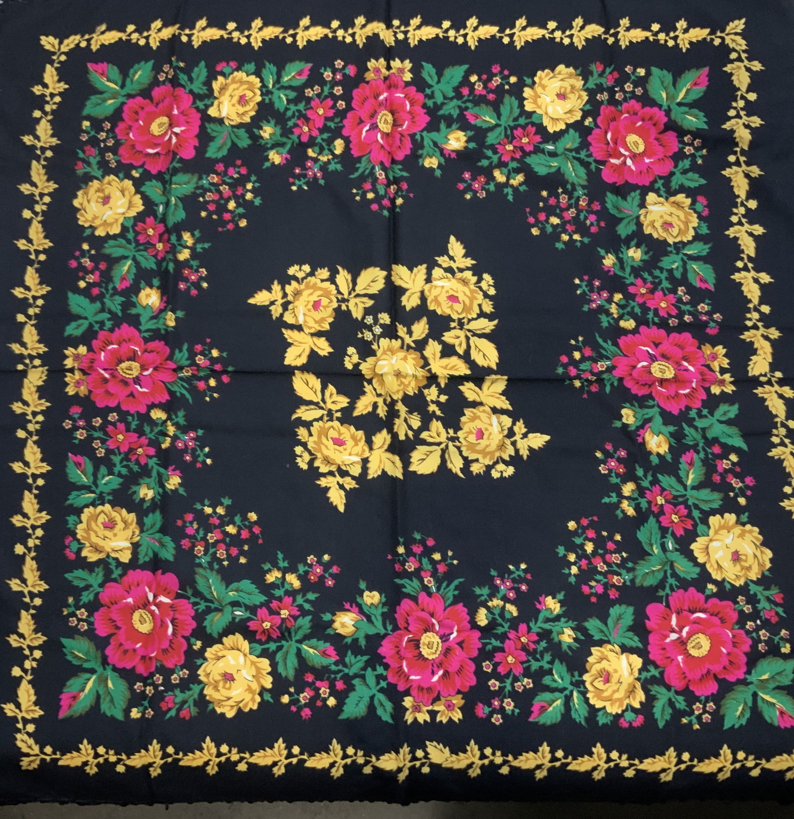 Floral Wool Shawl with Tassels: 32.5 x 32.25 in. Black wool shawl with tassels. Vibrant colored florals and leaf design in gold, pink, and emerald green. Additional tassels length is 6.5 in. Floral shawl, tassel shawl, bohemian flor