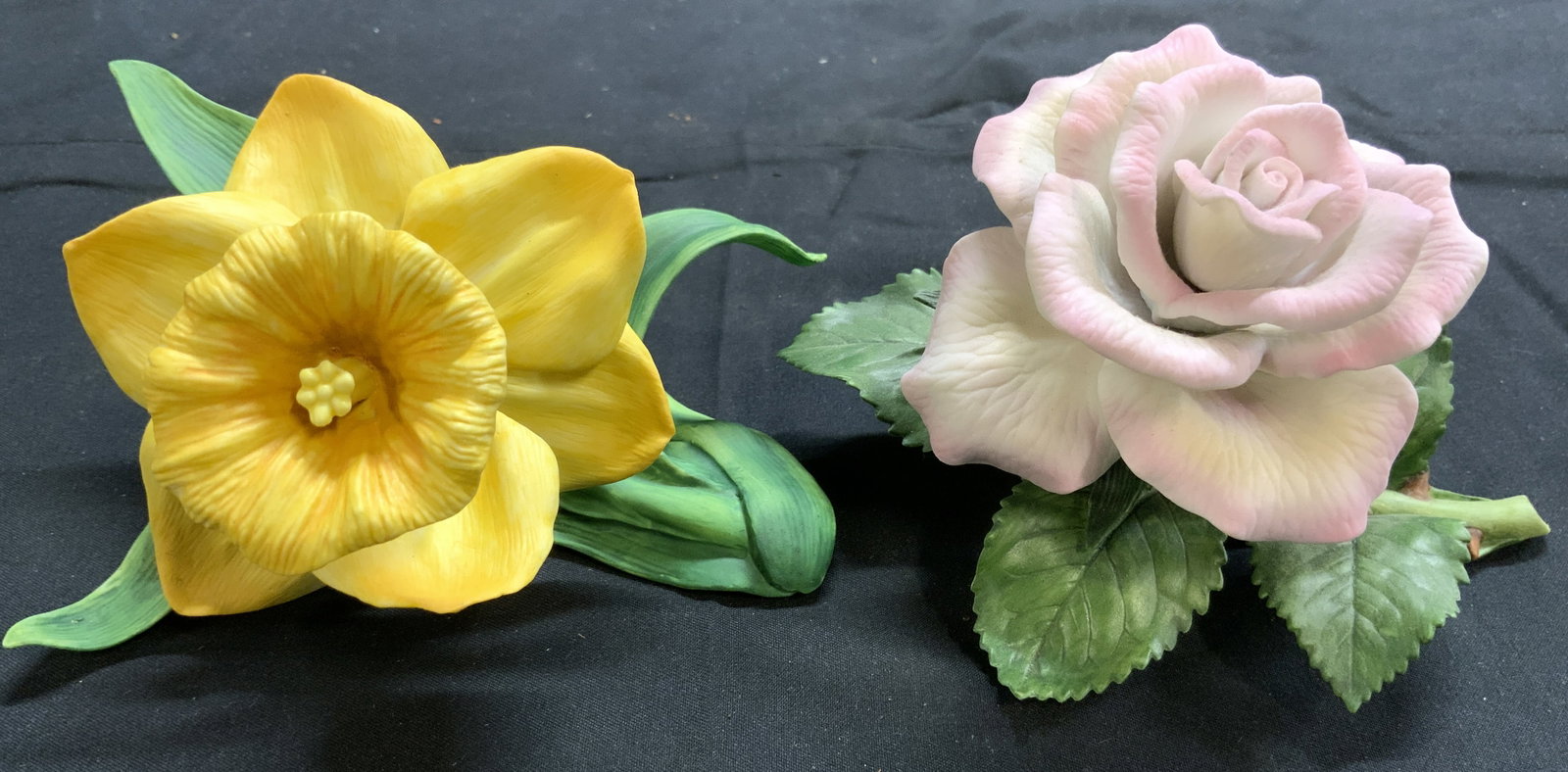 LENOX Porc Daffodil & Tea Rose Figures: Undersides are each marked LENOX. Lot includes 1 daffodil & 1 tea rose figure, each have green toned leaf detail. Pieces are each porcelain. Tea rose figure measures approximately 5 inches long 3.75 i