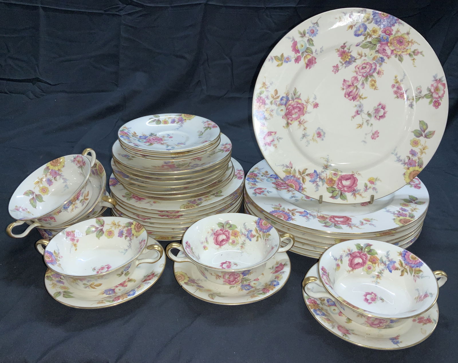 Castleton Sunnybrook Floral Chinaware 34, USA: Cream toned chinaware with colorful flowers, gilt rims. Made in USA. Castleton Sunnybrook pattern. 7 dinner plates, 1 has an underside rim chip. (10.75 in.) . 6 bowls and 6 saucers. Bowls have dual ha