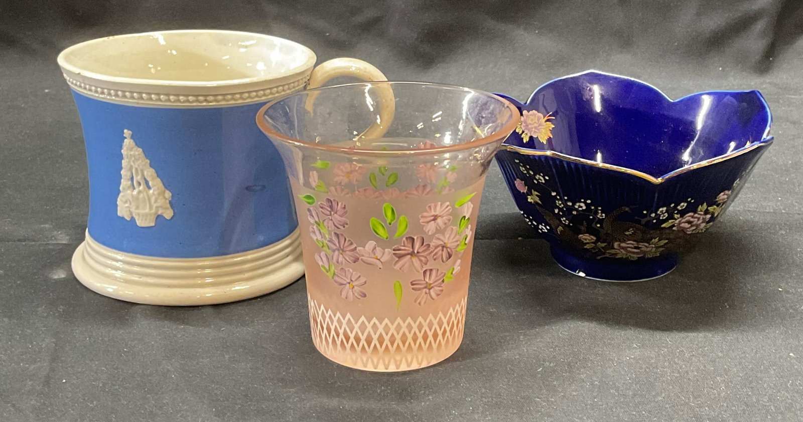 Lot 3 Twos Company Glass Vase, More: Twos Cimoany pink glass vase with floral motif. Signed to underside. Blue and white mug with raised floral motif. Cobalt blue porcelain lotus motif bowl with peacock and floral decoration. Largest pie