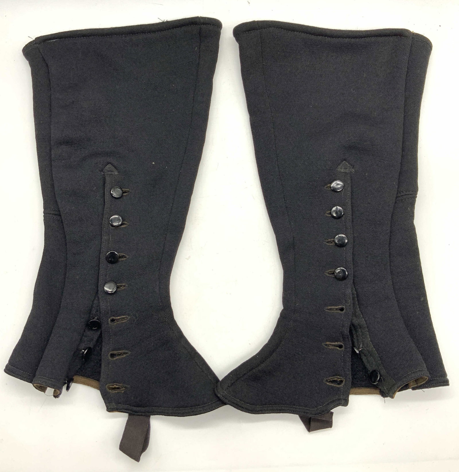 Pr Vntg Cotton Uniform Spats: Pair of vintage uniform boot spats, possibly made of black cotton with wool style fabric on interior. Side buttons bad straps for under boots. Approx 15 inches long and 8 1/2 in across at top, 9 in ac