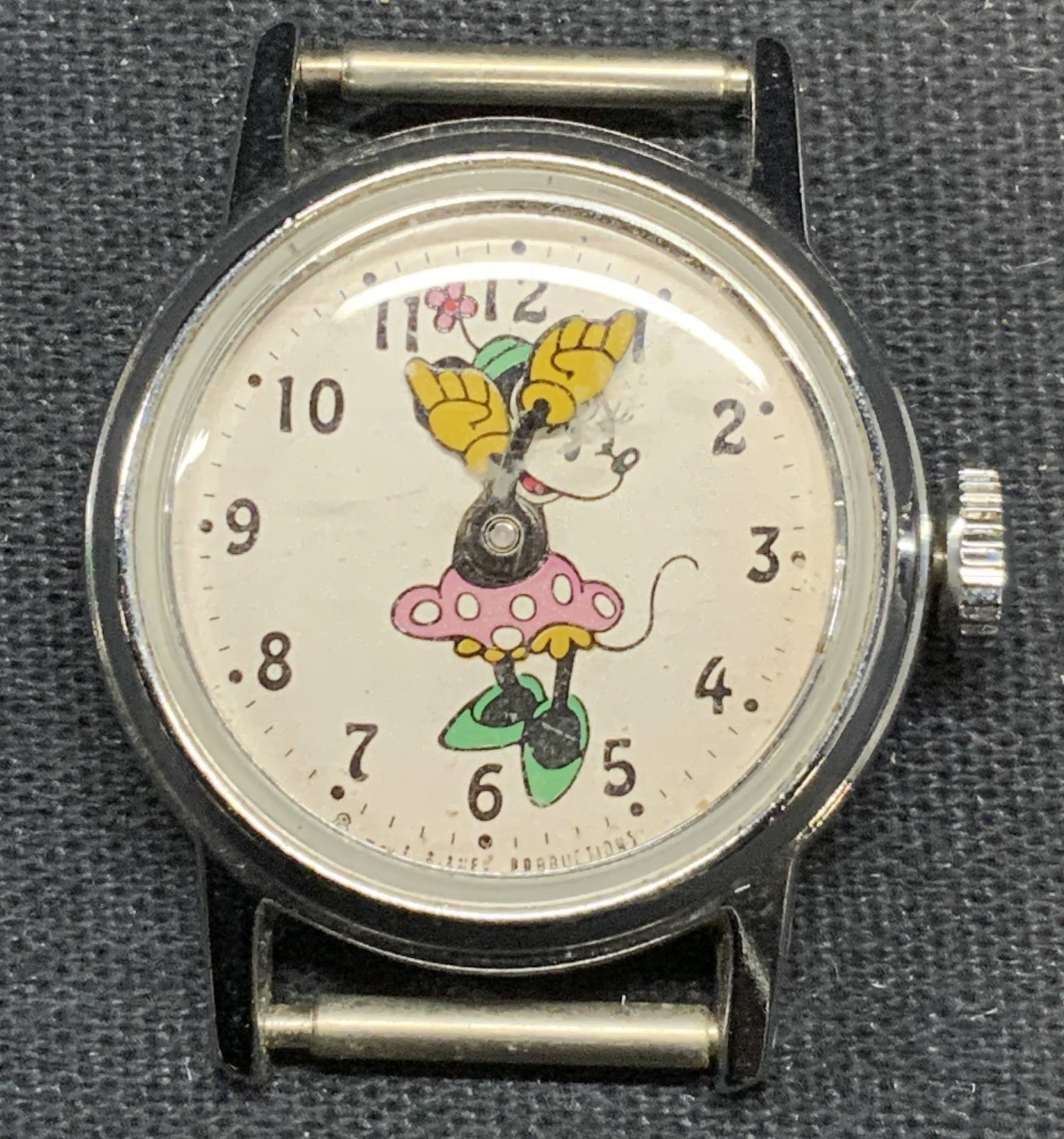 Vintage Disney Minnie Mouse Watch Face: Vintage stainless steel case watch face with Minnie Mouse motif. Measures approx. 1 inch diameter. Not tested for function. Includes jewelry case. Some surface wear including scratching observed. Esta