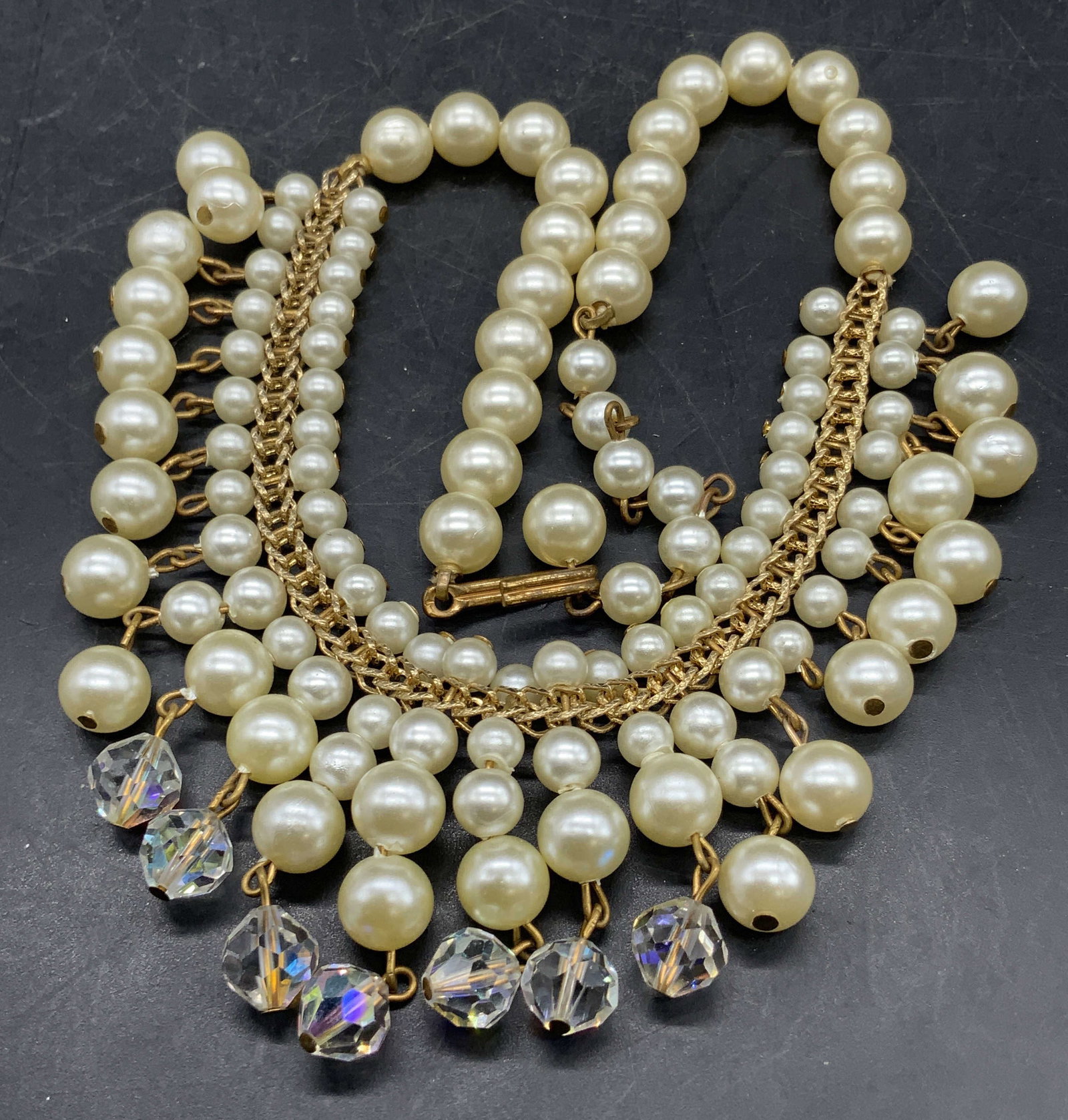 Vintage Pearlescent & Aurora Borealis Bead Choker: A vintage choker necklace comprised of pearlescent beads and faceted Aurora Borealis crystals. Fish hook closure. Necklace length measured end to end approx. 15 inches. Surface wear consistent with ag