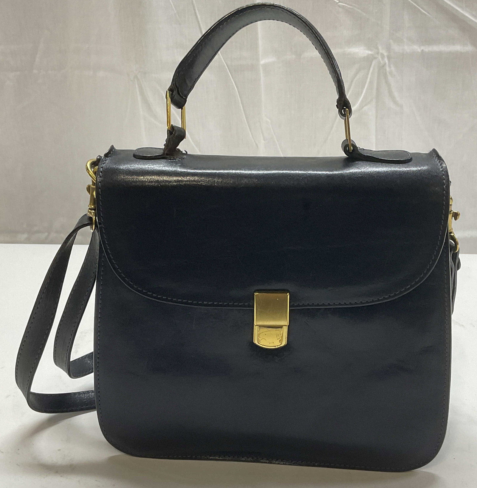 Vintage Brahmin Black Leather Handbag, USA: Vintage Brahmin black leather handbag. Made in USA. Signed to interior. Push lock closure, multiple pockets to interior. Measures approx. 9 x 3.5 x 8 inches. Includes Nordstrom dust bag. Wear to leath
