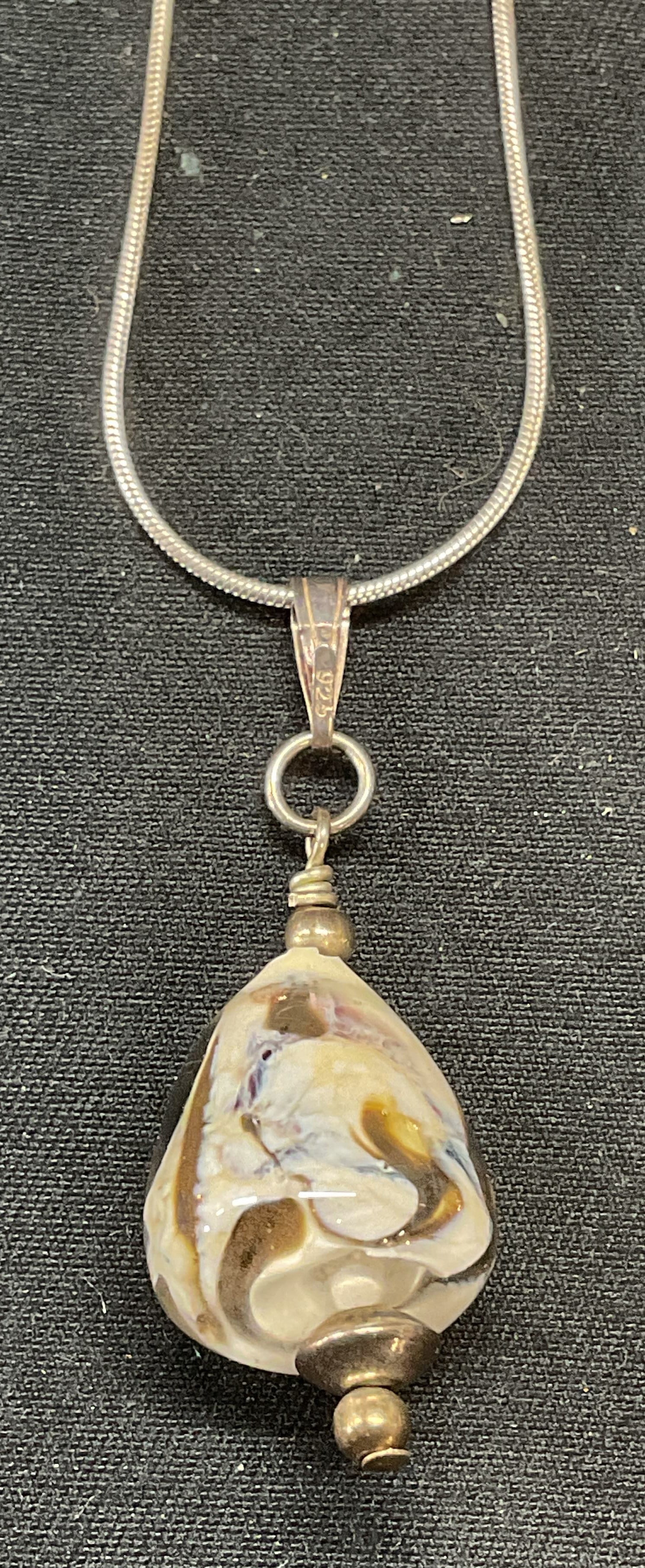 Sterling Silver Art Glass Pendant Necklace, Italy: Sterling silver necklace with art glass pendant. Marked 925, Italy on clasp. Drop length approx. 8.5 inches. Pendant measures approx. 1.5 inches long. Total weight 7.8 grams. Some surface wear includi