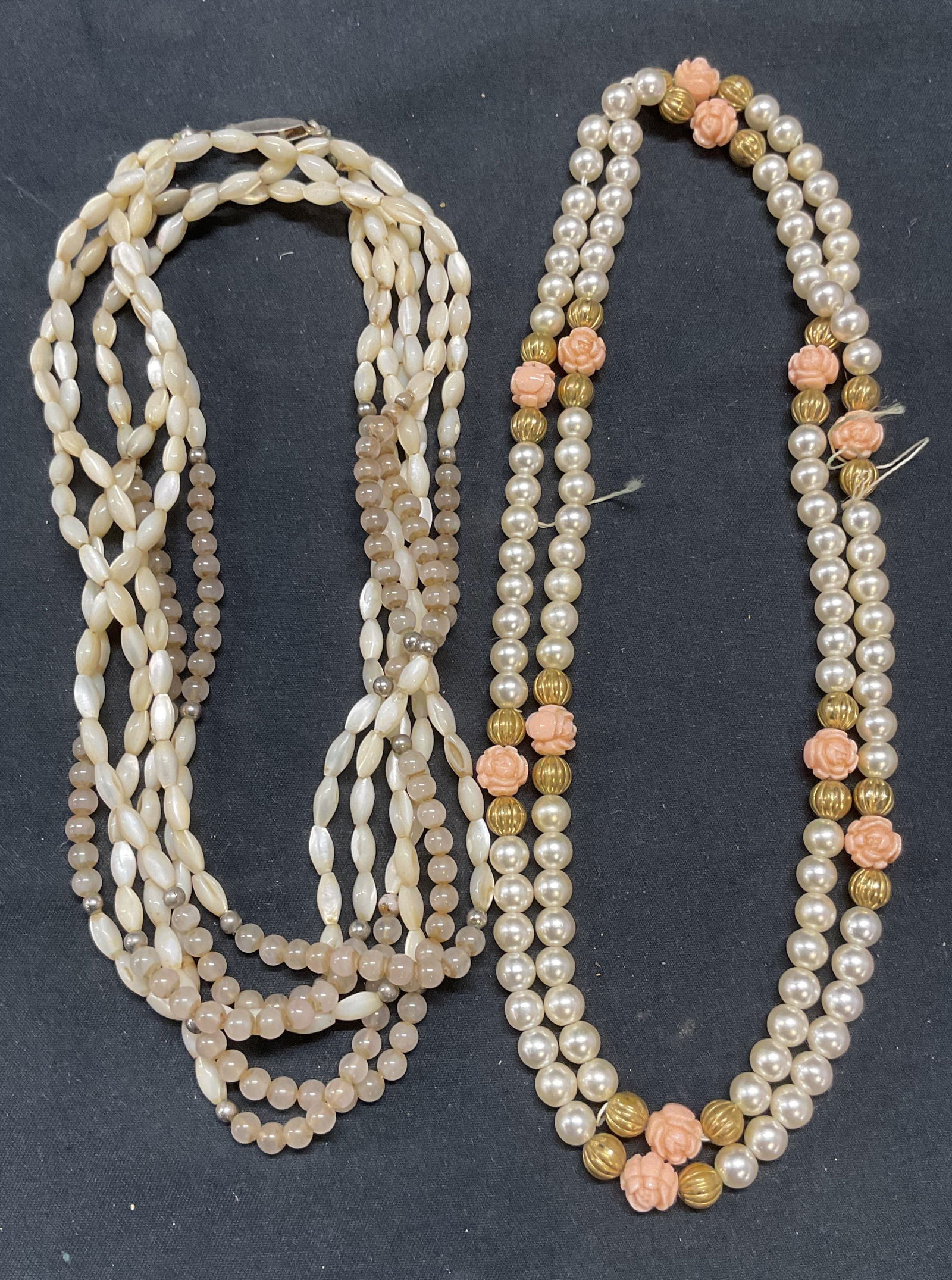 Lot 2 Mother of Pearl & Faux Pearl Necklaces: Lot of 2 jewelry pieces. Mother of pearl beaded multi strand necklace. Drop length approx. 13 inches. Faux pearl, gold tone, and flower beaded necklace. Drop length approx. 15.25 inches. All pieces ha