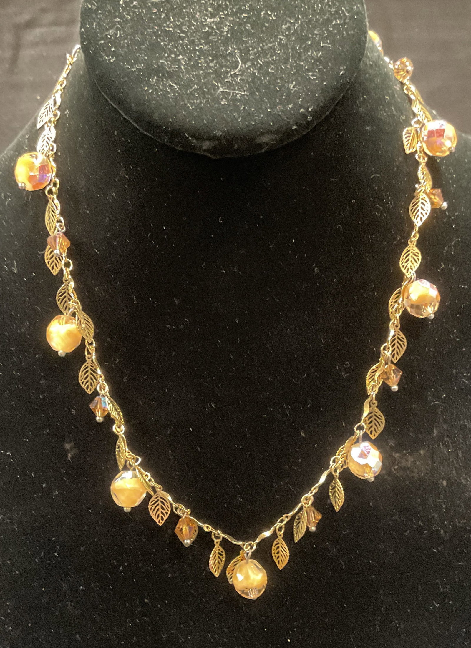 Vintage Gold Tone Leaf & Crystal Necklace: Vintage gold tone necklace with leaf motif and crystal beads. Drop length approx. 8.5 inches. Some surface wear including scratching observed. Jewelry, estate jewelry, costume jewelry, cocktail jewelr