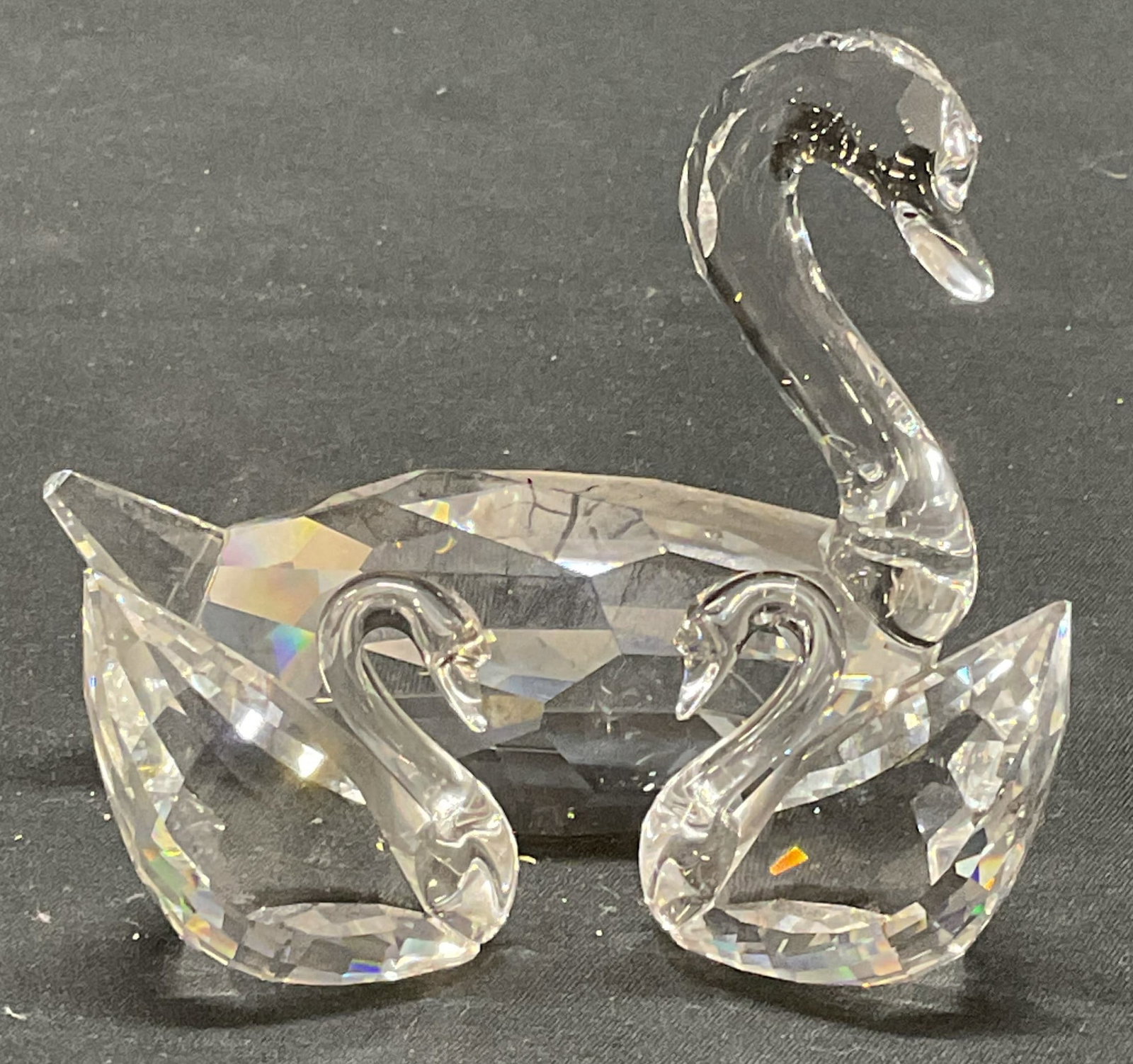 Lot 3 Swarovski Crystal Swan Figurals: Lot of 3 Swarovski clear Crystal swan figurals . All pieces signed to undersides. Largest measures approx. 3.5 x 1.5 x 3 inches. All pieces have some surface wear including scratching observed. Swarov