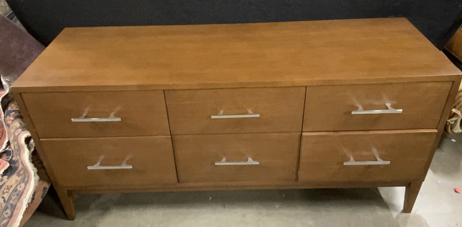 Mid Century Modern Style Six Drawer Dresser: A wooden mid century modern style six drawer dresser with tapered legs and chrome metal hardware. Measures approx. 28H x 60W x 20D in. Some wobble to piece, some surface wear and surface scratches pre