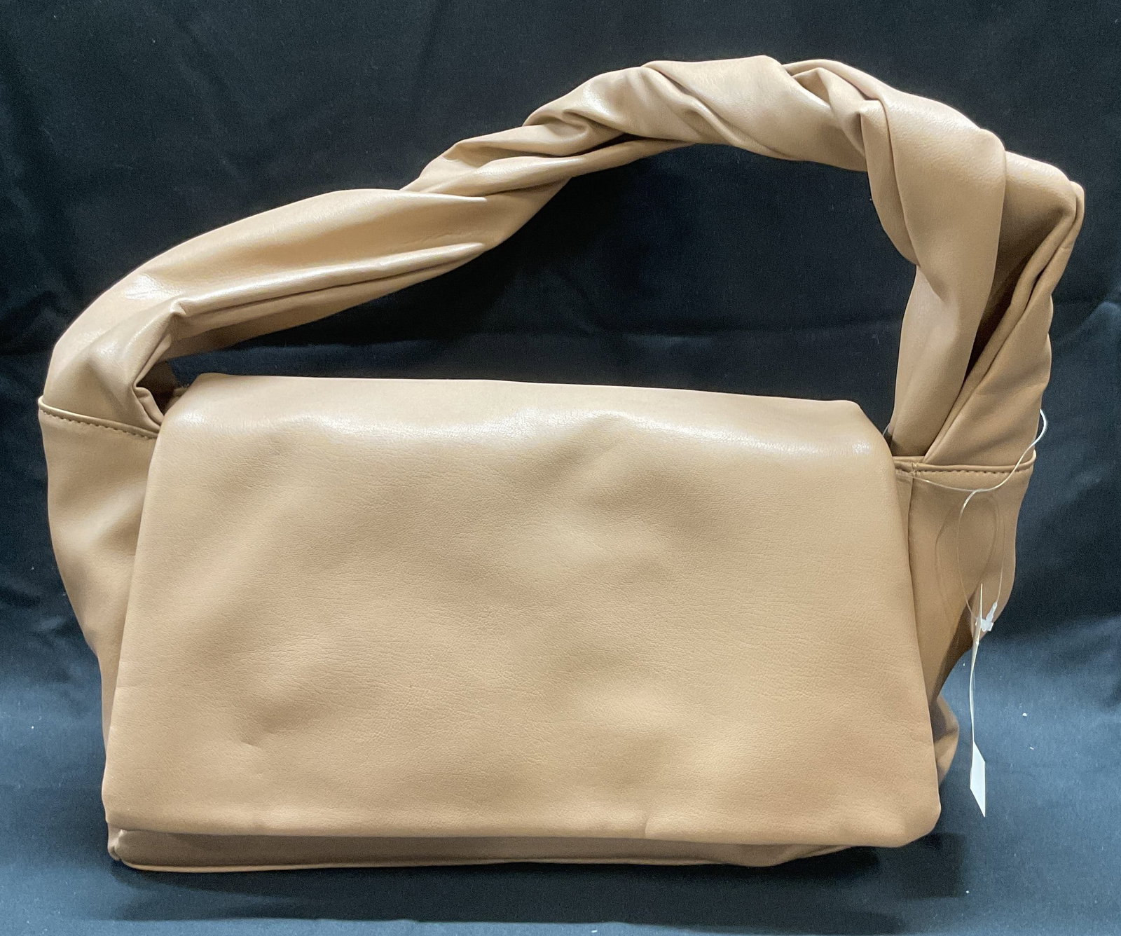 Tan Faux Leather Handbag, NWT: Tan faux leather handbag with fold over flap, exterior pocket, and interior pocket. Measures approx. 12 x 5 x 7 inches. New with tag. Some wear to material consistent with exposure. Ladies handbag, la