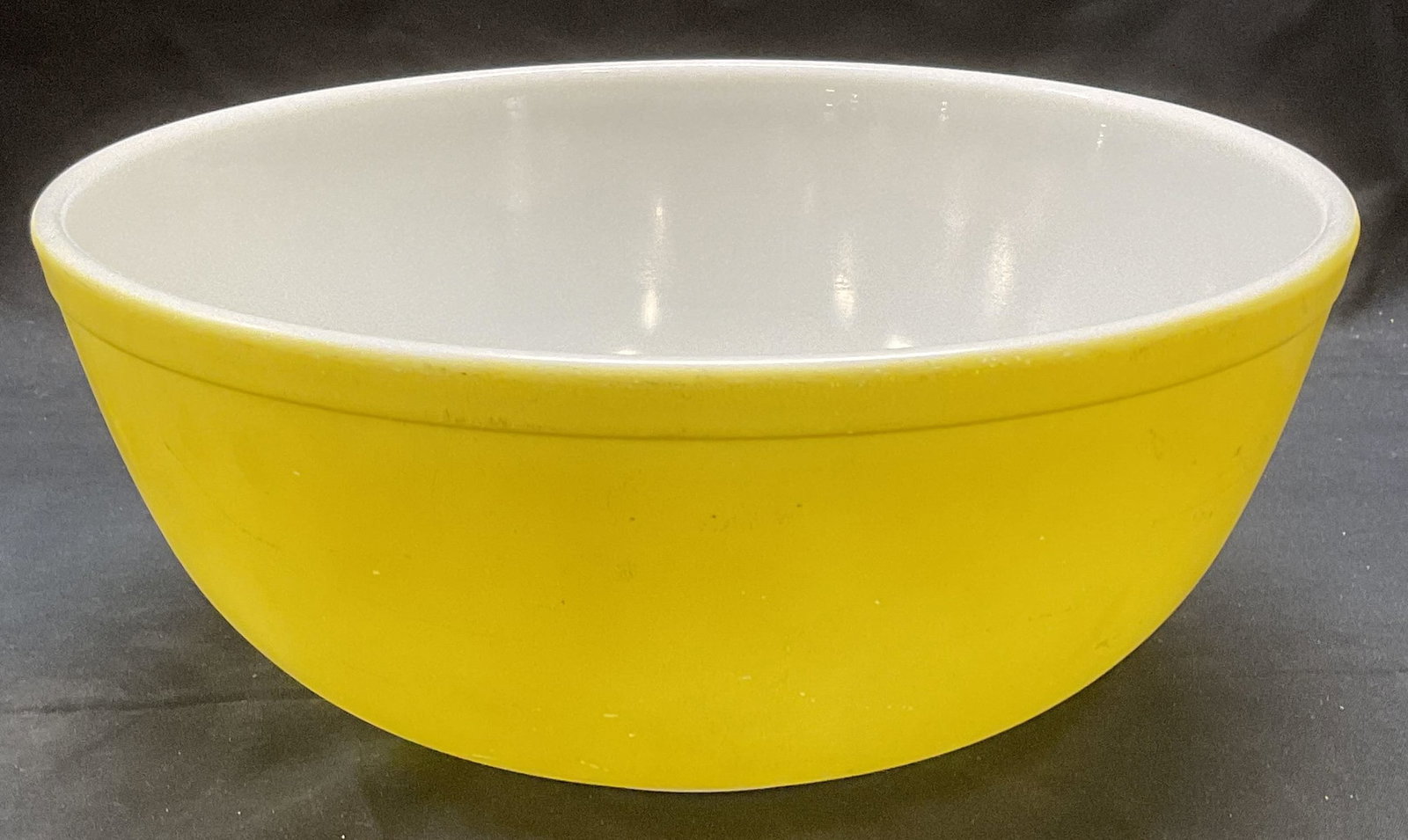 Vintage Pyrex Yellow Glass Mixing Bowl: Vintage Pyrex yellow glass mixing bowl. Trademarked to underside. Measures approx. 10.5 x 4.5 inches. Some surface wear including scratching observed. Pyrex, vintage Pyrex, Pyrex bowl, yellow Pyrex bo