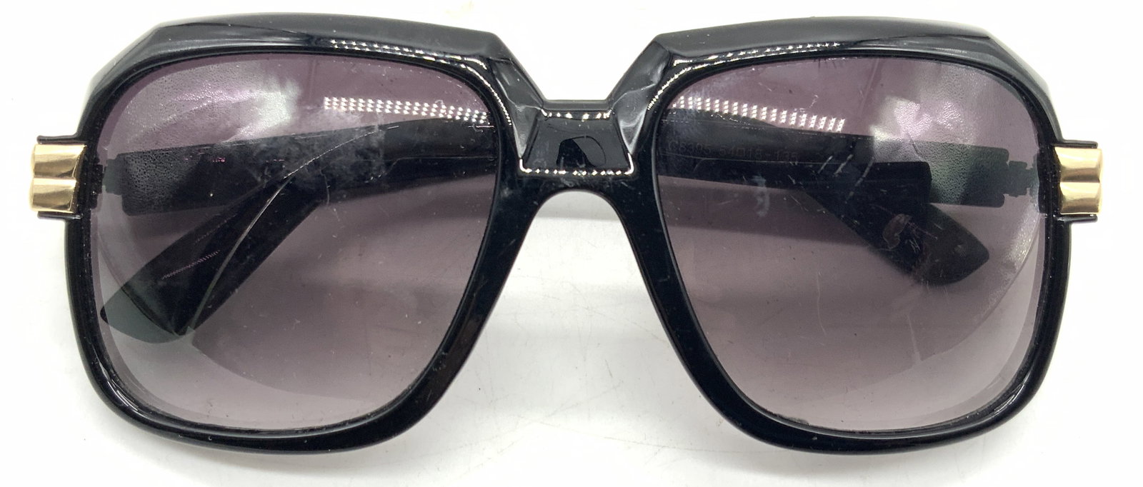 Cici Black Tn Sunglasses: Black framed pair of sunglasses with wide lenses, marked cici hand polished on arm. Approx 5.5 inches wide, arms being 5.5 inches, long and lenses being 2 inches wide. Moderate surface wearing due to