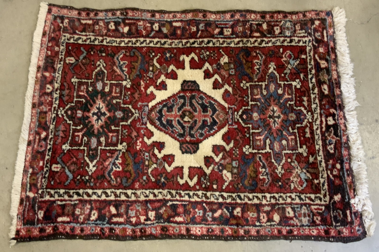 Vintage Persian Fringe Trim Rug: A vintage Persian fringe trim rug. Measures approx. 36L x 26W in. Measurement includes fringe trim. Primarily red with splashes of other colors throughout. Some wear consistent with age, use, and expo