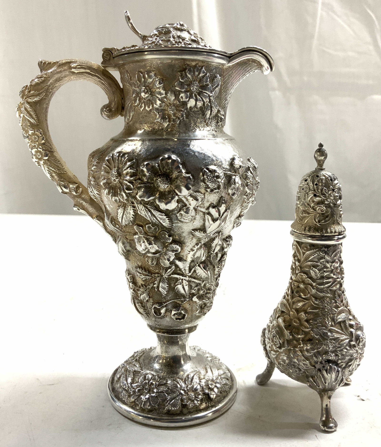 STERLING SILVER KIRK & SON S Shaker & Lidded Ewer: Underside of salt shaker reads KIRK & SON STERLING. Lot includes 1 Ewer with lid & 1 salt shaker. Each piece is intricate beveled Floral and leaf detail. Shaker has 3 feet. Ewer has scrolled handle. E