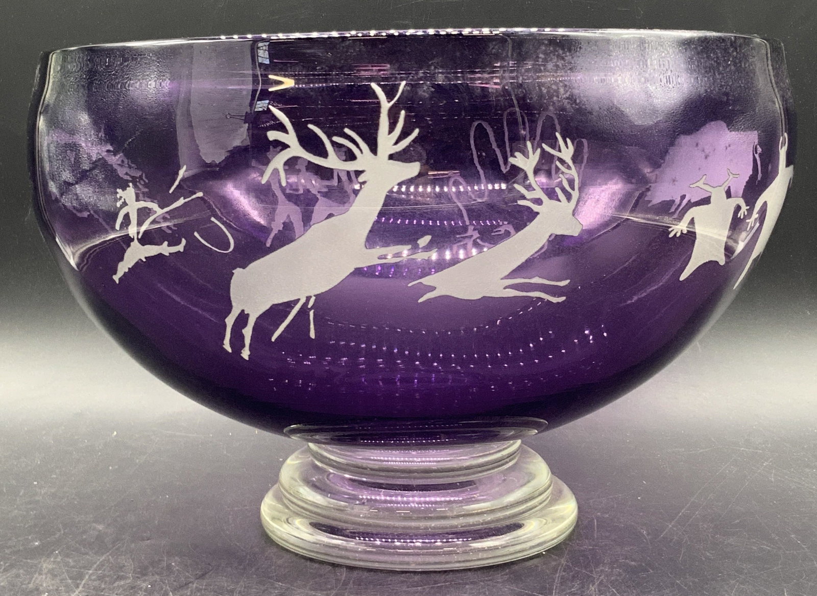Steven V Correia Sgn Etched Amethyst Glass Bowl 92: Steven V Correia Etched Amethyst Glass Bowl. Designs feature animals and people. Underside signed 1992, L.E. BSB8190 26/200. Measures approx. 10.75W x 7.25H in. Some surface wear consistent with age, 