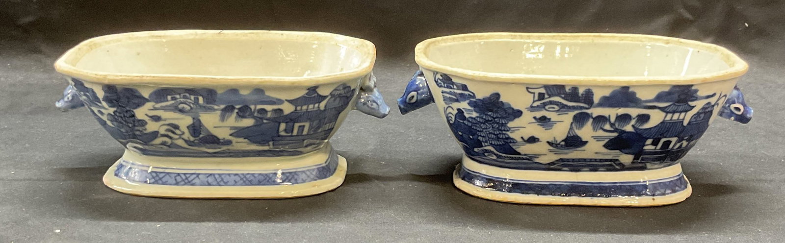 Pair Antique Chinese Porcelain Blue & White Bowls: Near pair of antique Chinese porcelain footed bowls or tureens. Antique circa 19th century. Hand painted in blue white with landscape motifs and boar head finials. Sizes vary slightly, approx. 6.5 x 4