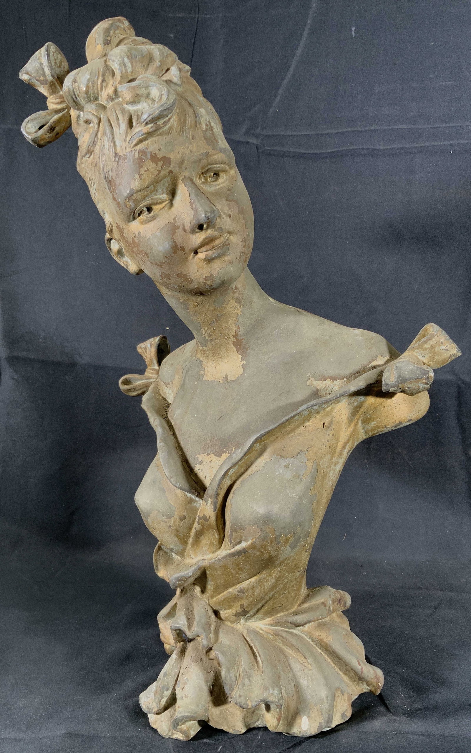 Art Nouveau Style Brass Spelter Womans Bust: Brass Spelter with remnants of gilt. Statue depicts the bust of a woman in an art nouveau style. She has bows on each shoulder from her dress and an updo in her hair with another bow. Inscription on v