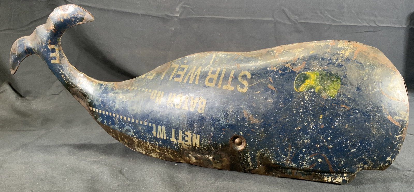 Reclaimed Metal Whale Art Figural Nautical Decor: Sculpture with reclaimed metal. Subject depicts a whale with its tail in the air. Losses to fins on each side. Whale measures approx. 20.5 W x 7.5 H x 3.5 D in. Wear to metal, tarnishing to metal. Rub