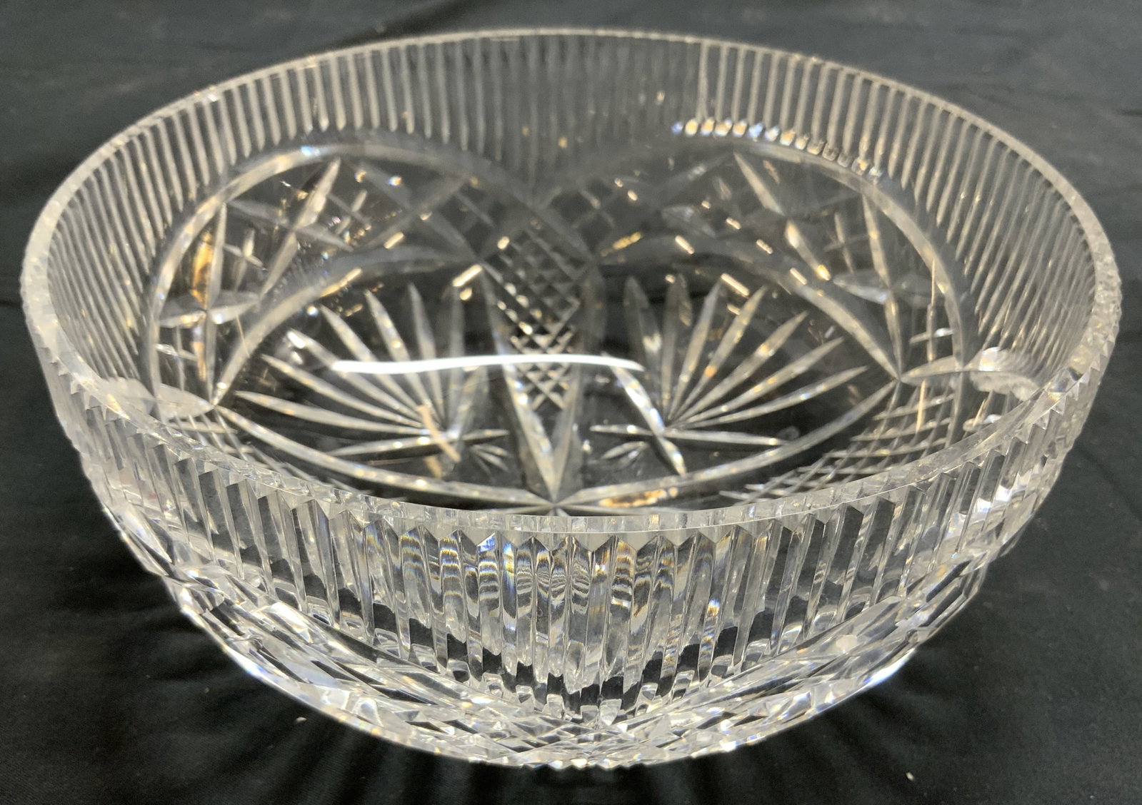 WATERFORD Trademarked Crystal Bowl Vessel: Underside is trademarked WATERFORD. Bowl is cut crystal. Piece has intricate geometric relief detail. Bowl has circular form. Piece measures approximately 8 inches diameter 3.5 inches tall. Bowl, vess
