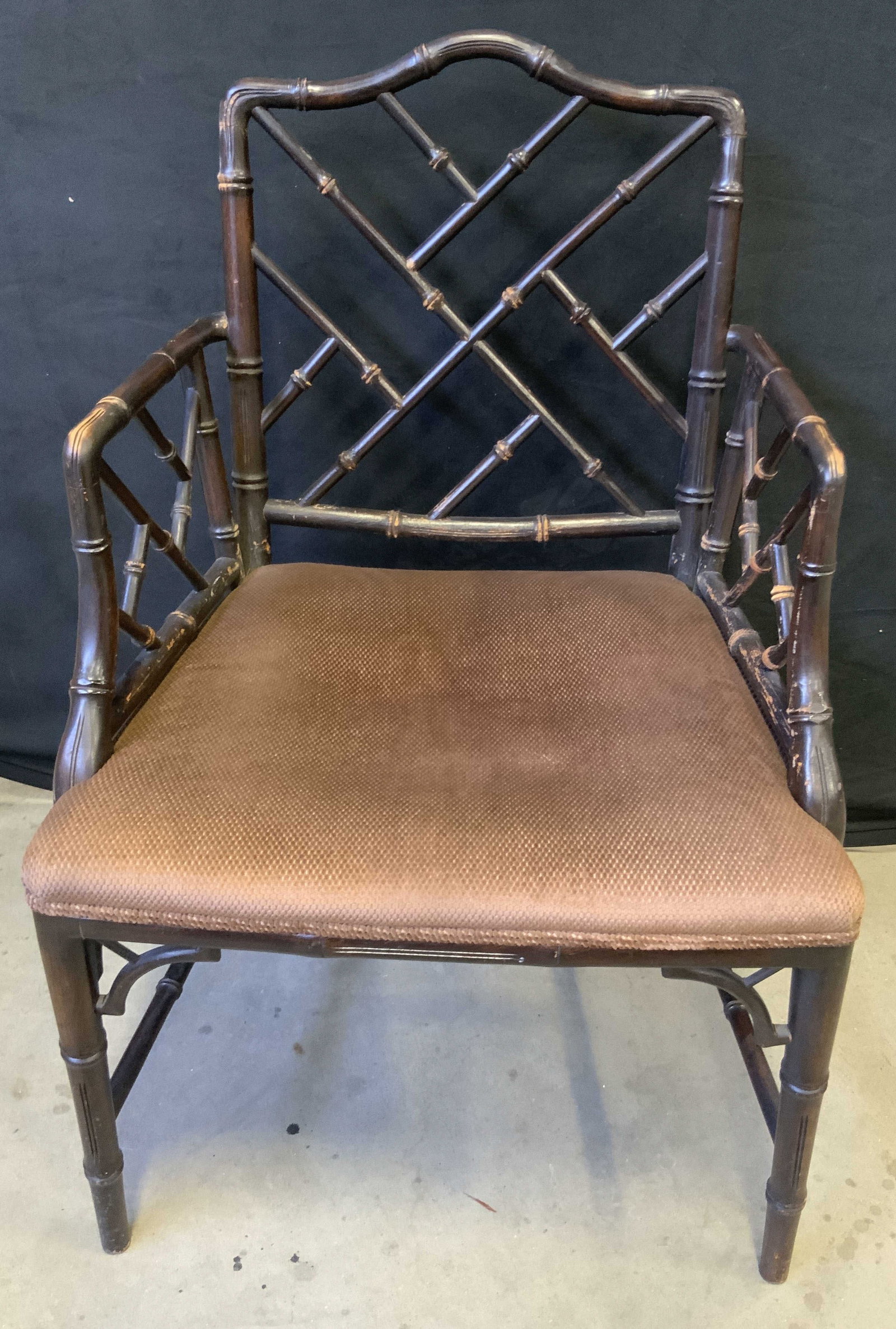 Vintage Chippendale Bamboo Style Upholstered Chair: A vintage Chippendale style armchair featuring an upholstered seat and faux bamboo. Dark wood finish. Soft hand upholstery. Measures approx. 22W x 19D x 35.5H in. Some surface wear consistent with age