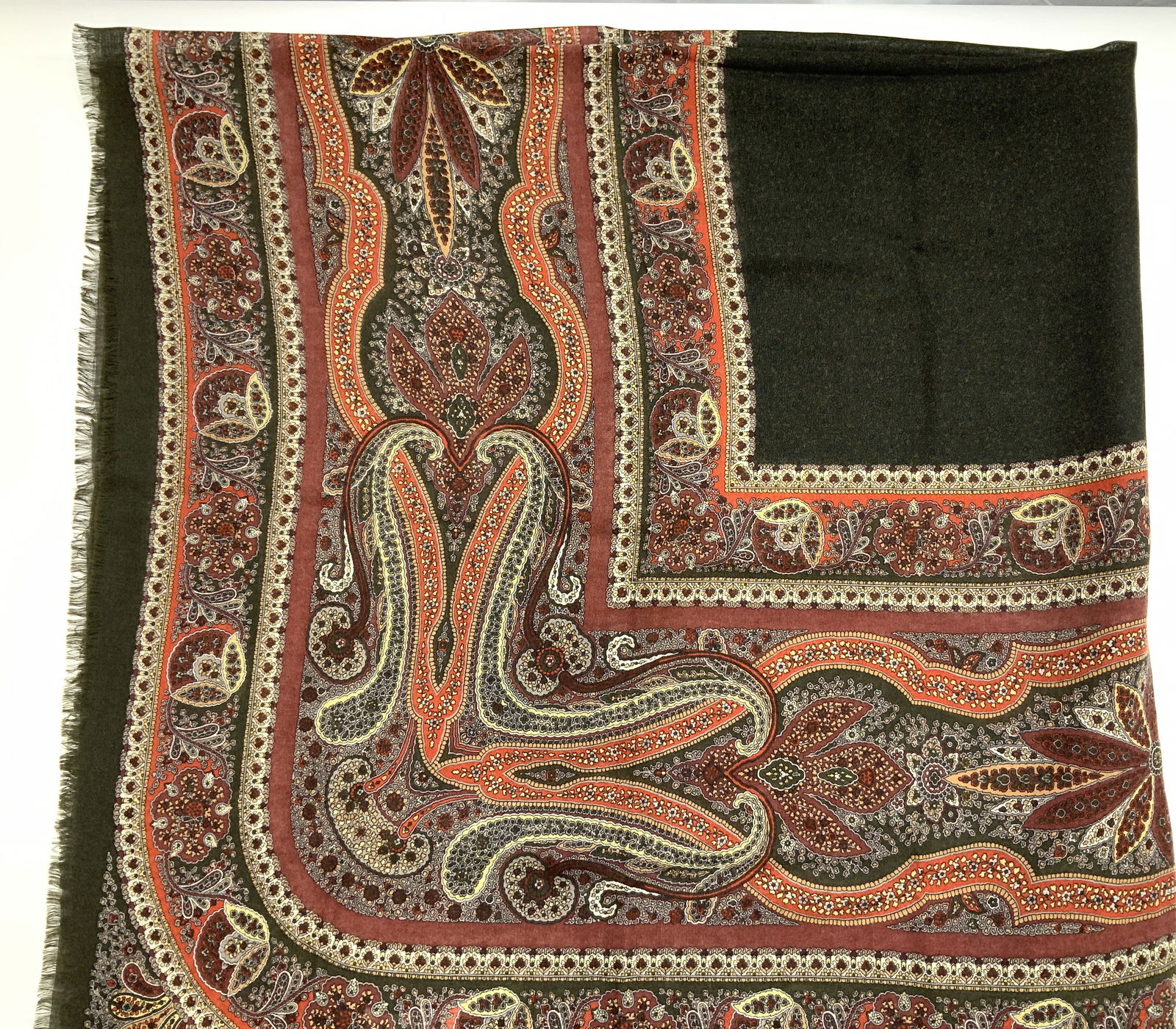 Montero Paisley Wool/Silk Shawl w Fringe, Italy: Montero oversized Olive green with Mughal print in red, cream , yellow, and orange. Shawl measures 54 x 53 in. Lightweight woven wool and silk 70%/ 30%. In like- new condition. Made in Italy with labe