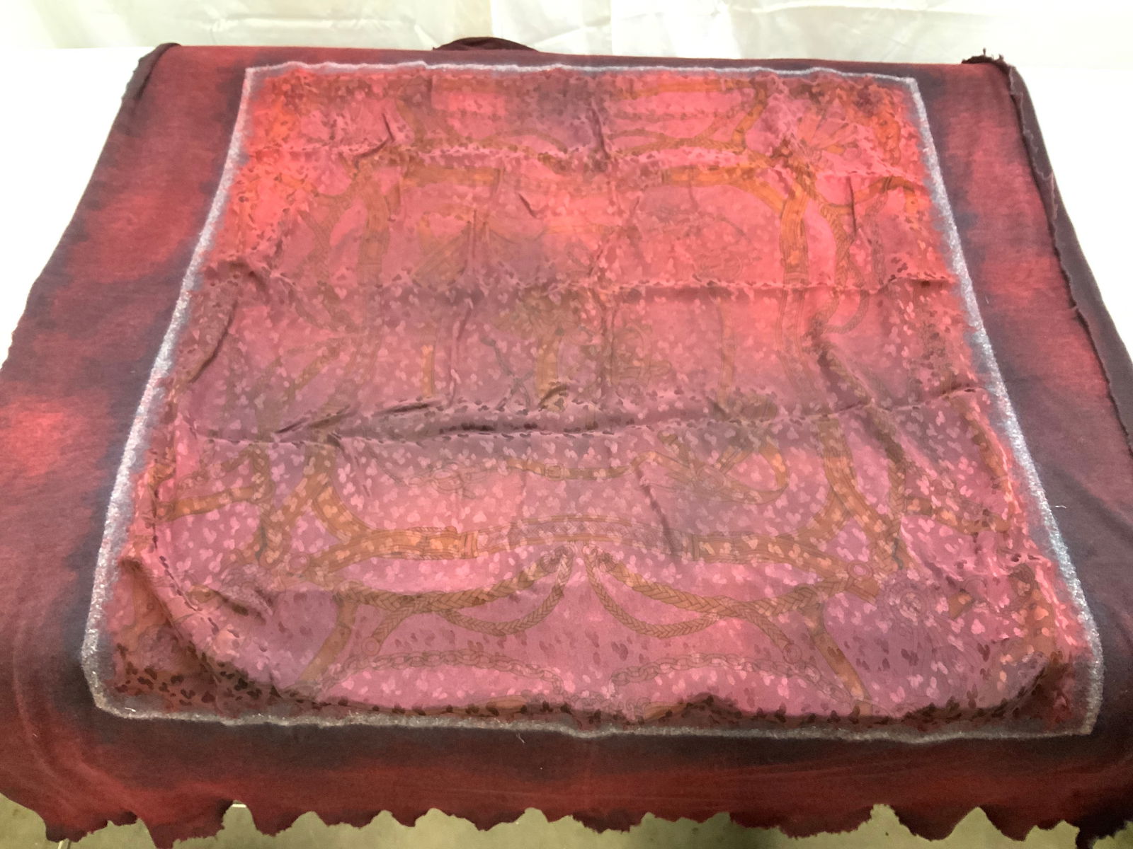 Avant Toi Cashmere & Silk Knit Wrap, Italy: Raw edge knit cashmere wrap in burgundy with a frontside muted animal print and stirrup and chain design silk panel. Measures 43.5 x 51.5 in. In like-new condition. Made in Italy. 70% cashmere, 30% si