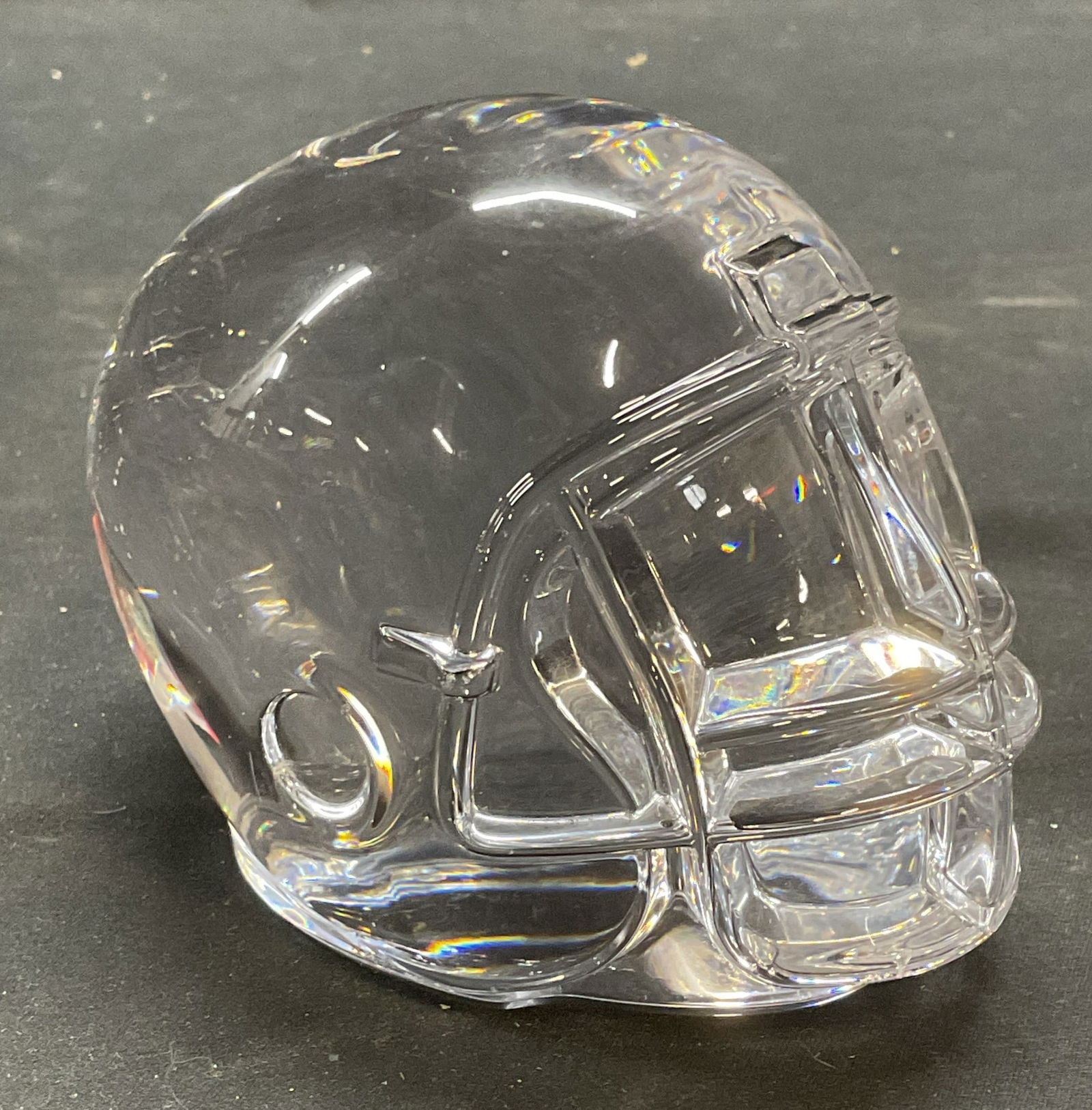 Tiffany & Co Crystal Football Helmet Paperweight: Tiffany and Co crystal football helmet motif figural paperweight. Solid crystal, piece has weight. Signed to underside. Measures approx. 3 x 4 x 3.5 inches. Some surface wear including scratching obse