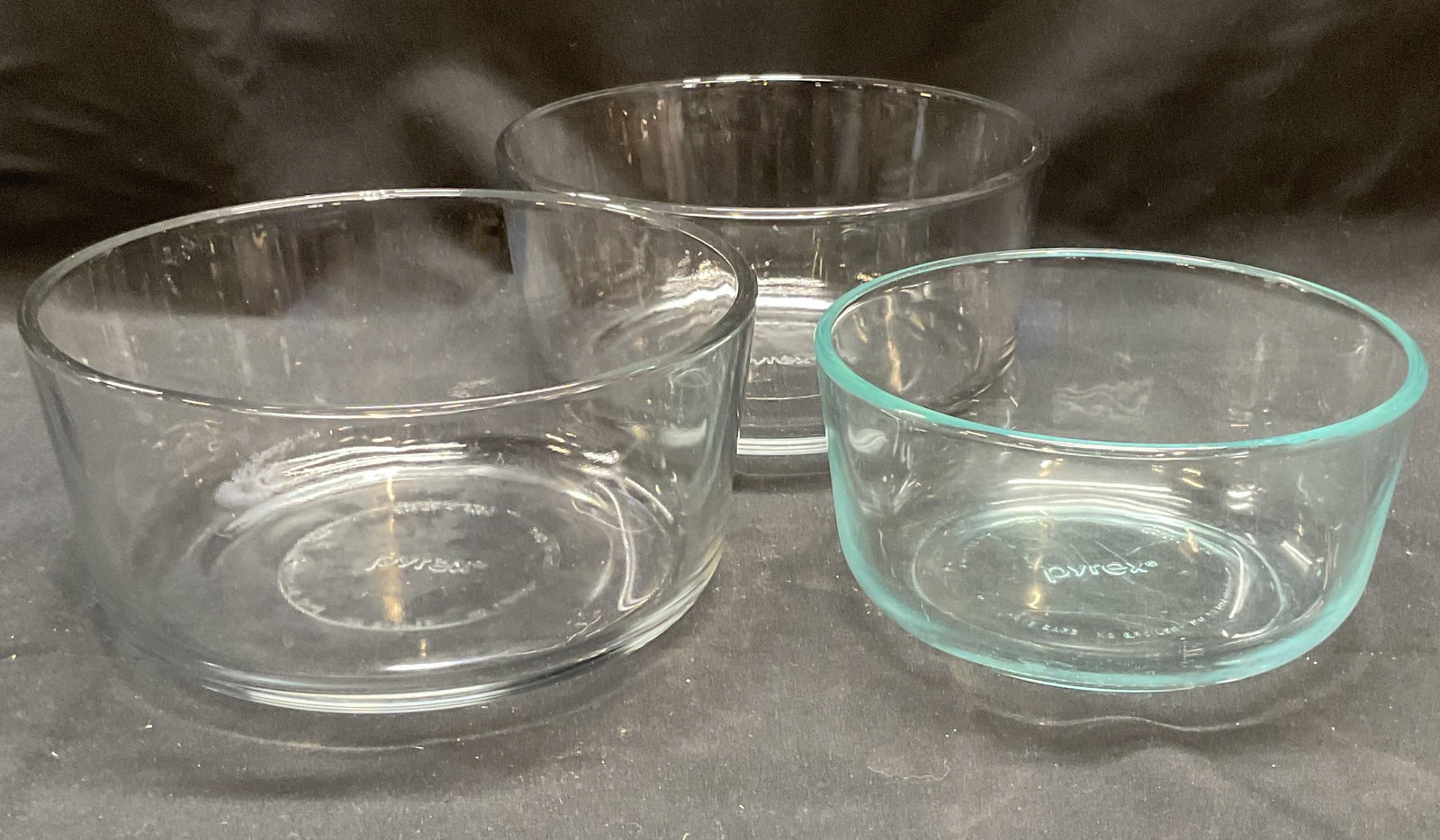 Lot 3 Pyrex Glass Bowls, USA: Lot of 3 Pyrex glass bowls. Made in USA. 2 bowls measure approx. 7 x 3 3/8 inches. 1 bowl measures approx. 6 x 3 inches. All pieces signed on bases. All pieces have some surface wear including small c