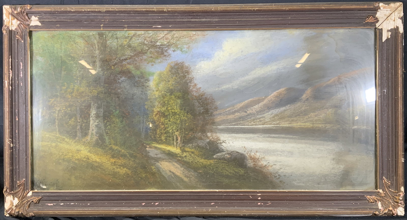 Framed Hudson Valley Landscape Pastel Painting: Pastel painting on paper. Subject depicts a landscape view of a tree lined narrow road going along the Hudson River. Framed in a wooden brown frame with scrolling molding in the corners. Frame measure