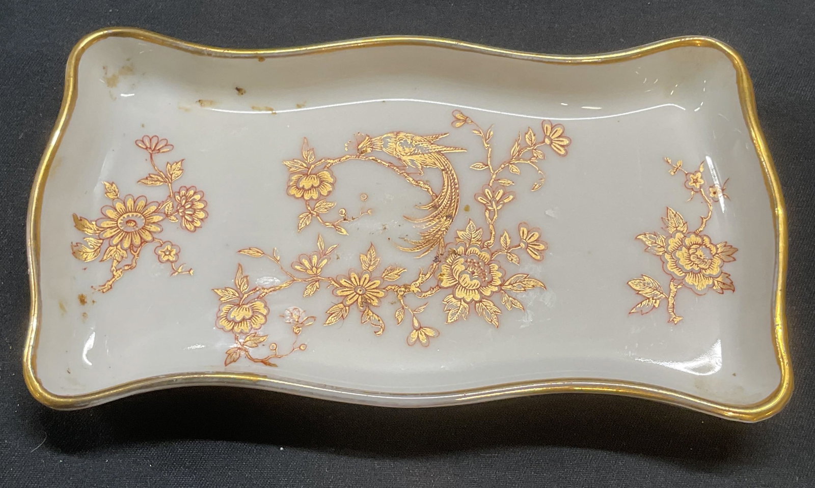 Vintage Limoges Gilt Floral Porcelain Dish, France: Vintage Limoges porcelain dish. Had painted floral and peacock motif with gilt decoration. Signed to underside. Made in France. Measures approx. 5 x 2.75 inches. Property of P. T. Barnum estate by fam