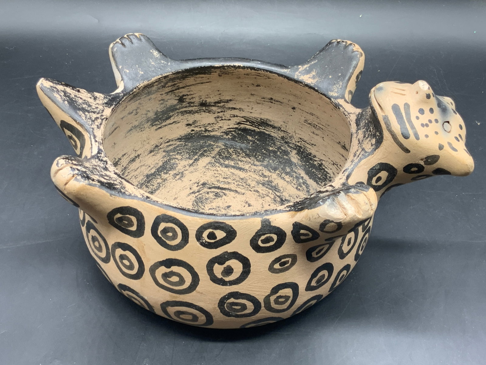 Vintage Handmade Pottery Leopard Figural Bowl: A vintage handmade and hand painted pottery leopard / cheetah figural bowl. Measures approx. 5H x 10W in. Chipping and discoloration present. Tableware, vessel, bowl, dishes, pottery, Vintage Handmade