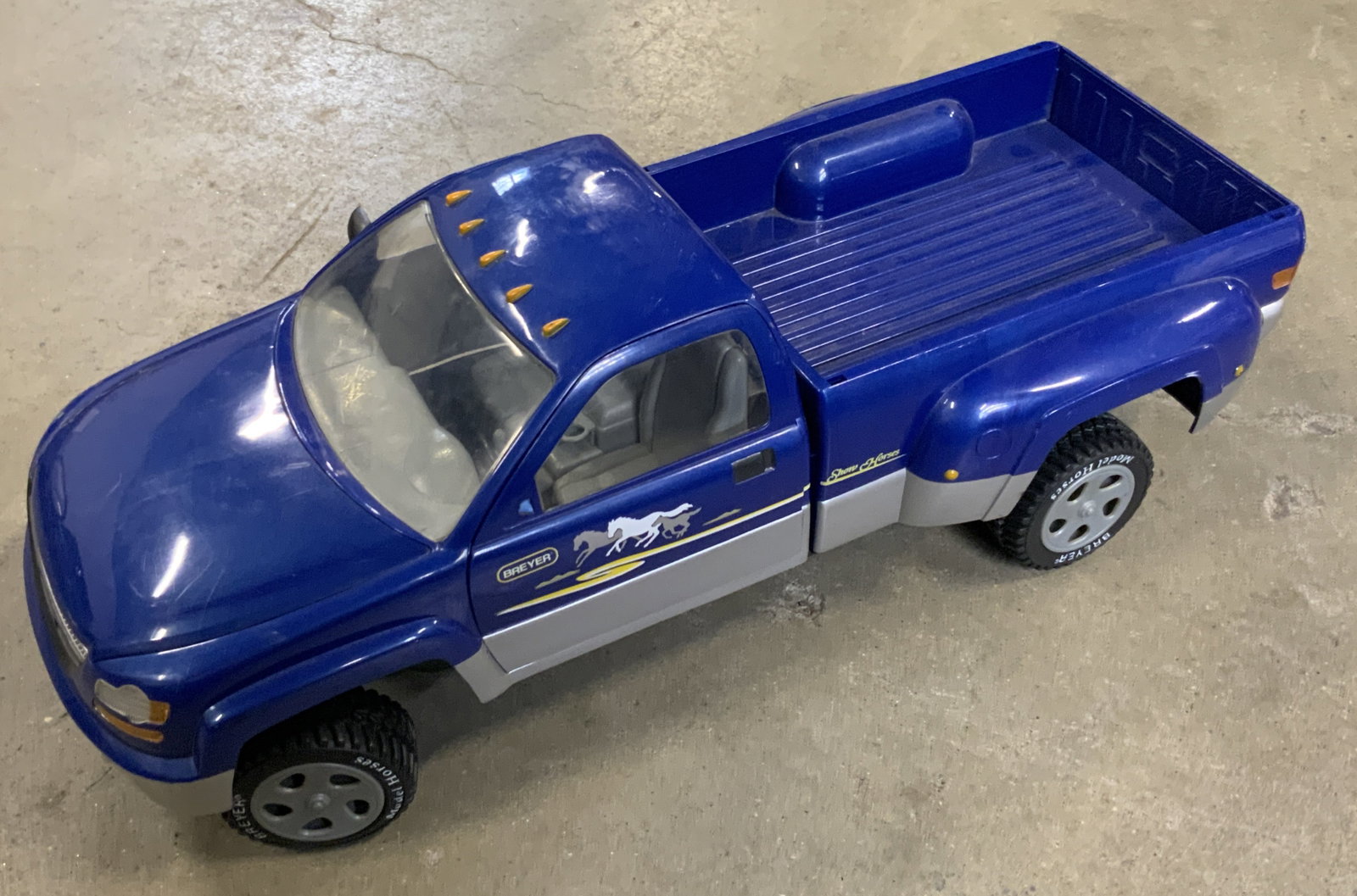 BREYER Snow Horses Blue Truck Childrens Toy: A Breyer Snow Horses blue truck childrens toy. Crafted from composite materials. Some pieces of the vehicle are articulated. Measures approx. 7.5H x 21W in. Measured at widest point. Losses, discolora