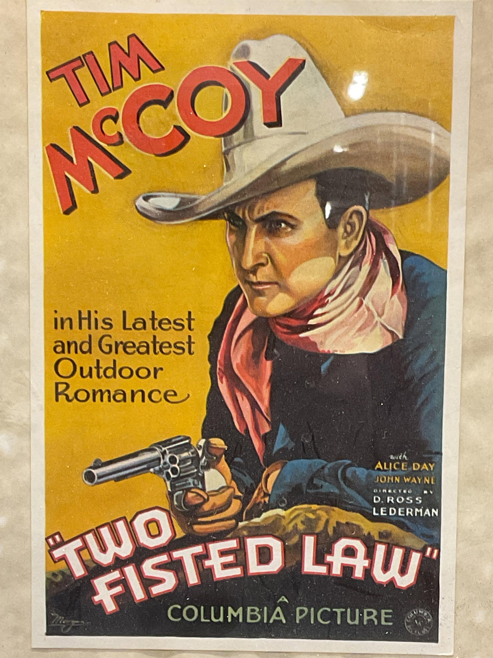 Tim McCoy Two Fisted Law Lithograph Poster: Framed Tim McCoy Two Fisted Law lithograph movie poster reproduction. Image of a cowboy with gun. Framed in a blue metal frame. Not examined out of frame. Measures approx, 10 x 8 inches. Some surface 