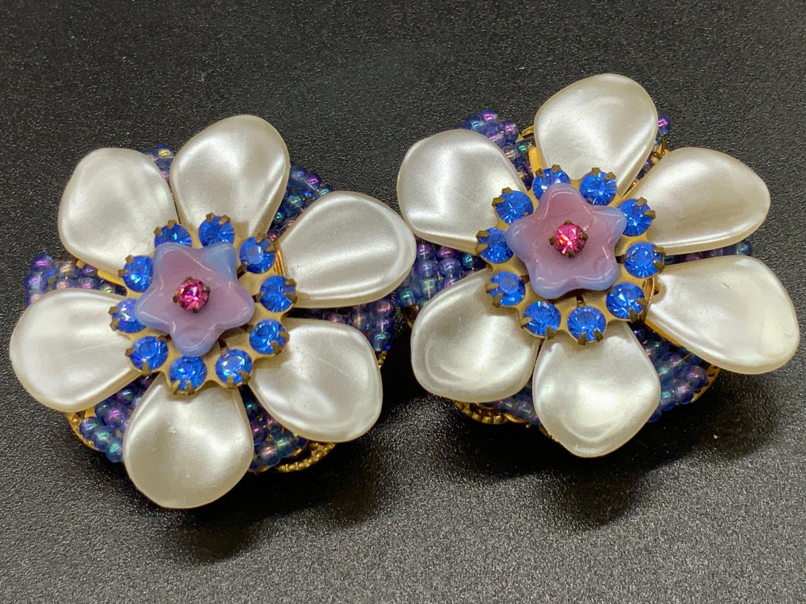 IAN ST. GIELAR Bejeweled Floral Clip On Earrings: Vintage bejeweled clip on earrings by Ian St. Gielar. Crafted from pearlescent beads, seed beads, faceted rhinestones, and gold tone metal. Verso features clip on backings and one reads IAN ST. GIELAR