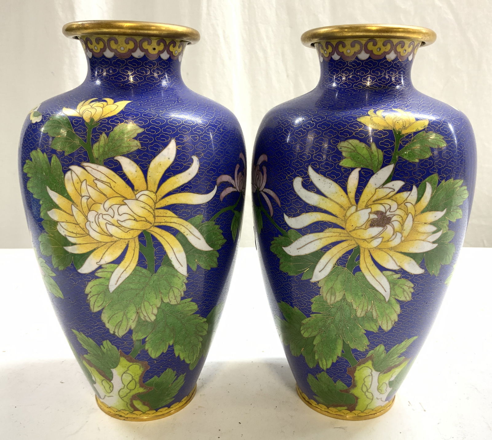 Pt Vntg Asian Cloissonne Enamel Vases Vessels: Lot includes vases. Each are vintage. Vases are each cloisonne enamel. Vases each have intricate multi toned floral, leaf & geometric detail. Vases each have gilt metal interiors. Vases each measure a
