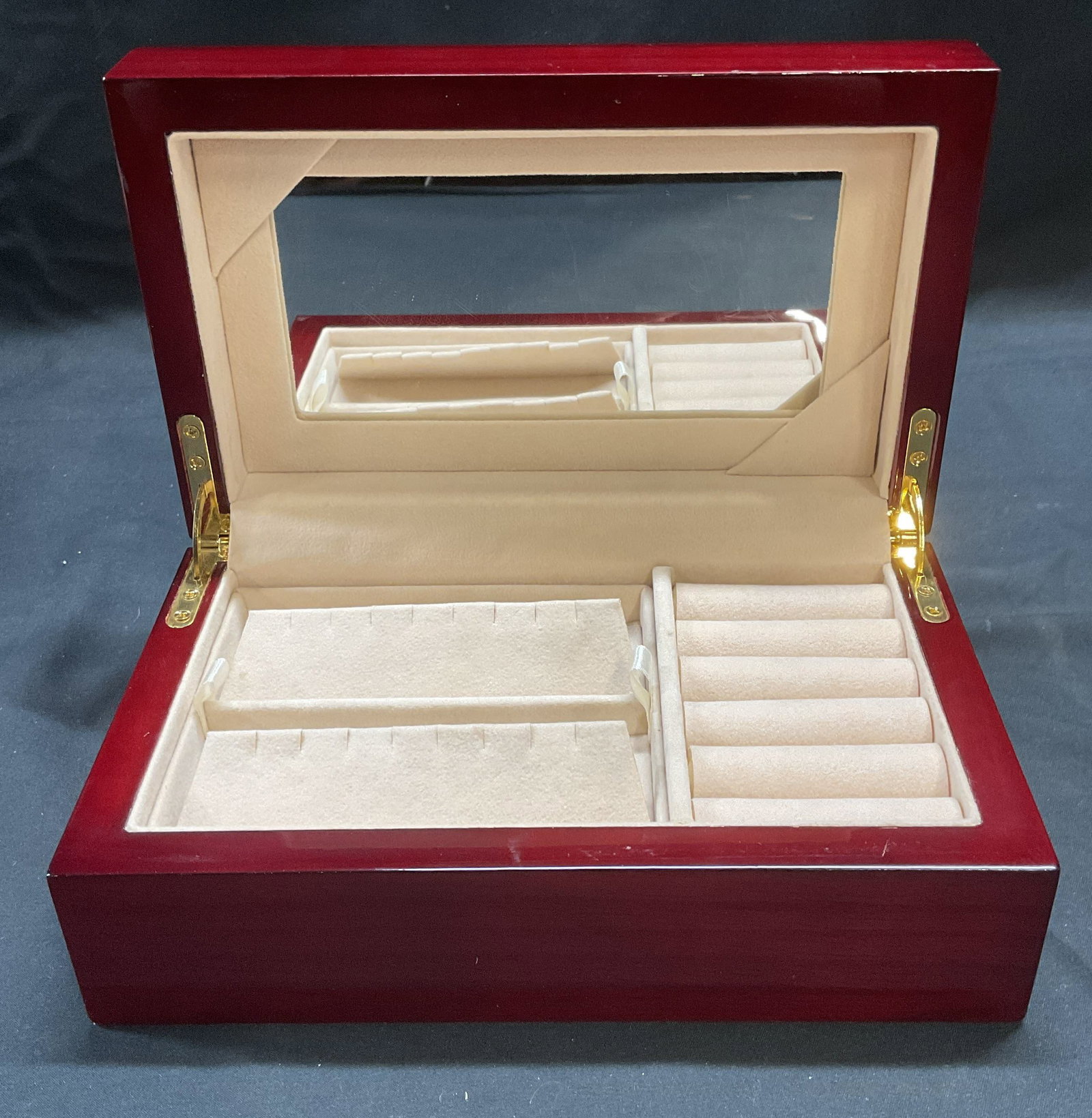 Lacquered Wood Jewelry Box with Mirror NWOT: Lacquered red toned wooden jewelry box. Mirror to interior and multiple fitted compartments and removable tray with felt lining. New without tag. Measures approx. 8.25 x 5 x 3.25 inches. Some surface 