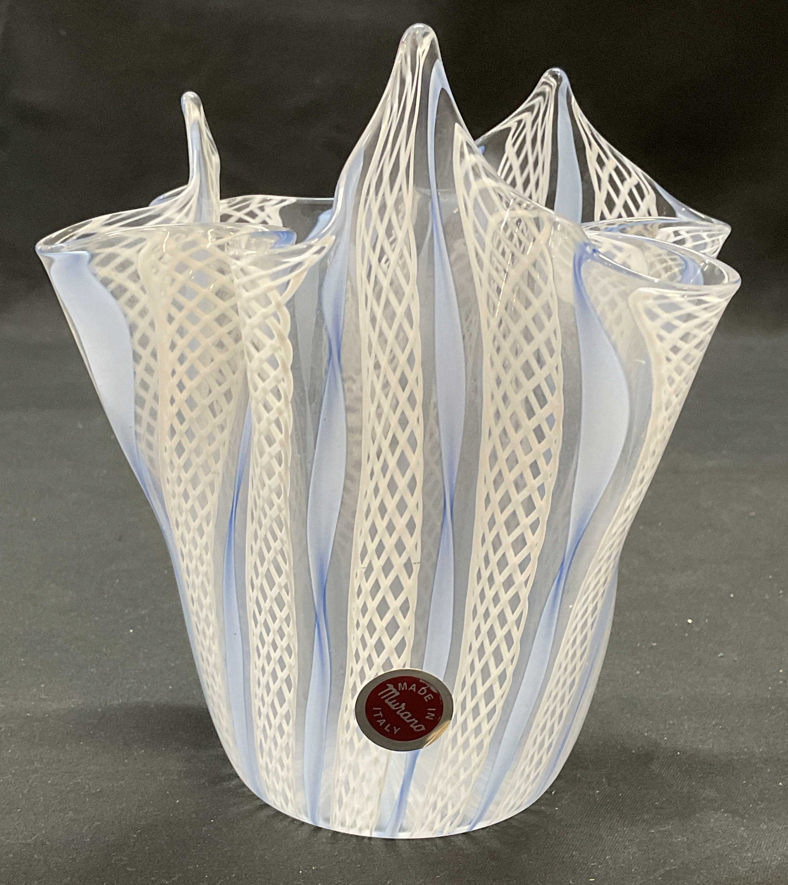 MURANO Blue & White Glass Latticino Vase, Italy: MURANO Art glass vase. Blue and white Latticino pattern with handkerchief rim. Made in Italy, signed on sticker. Measures approx. 5 x 5.5 inches. Some surface wear including scratching observed. MURAN