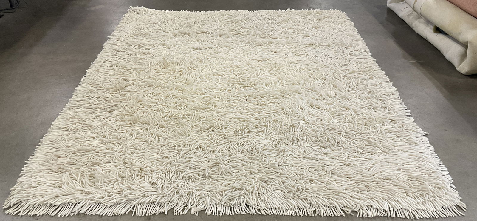 Cream Toned Shag Rug: A cream toned shag rug. Measures approx. 85L x 60W in. No material tag, possibly crafted from wool. Surface wear consistent with age, use, and exposure. Rugs, carpets, accent rugs, area rug, Cream Ton