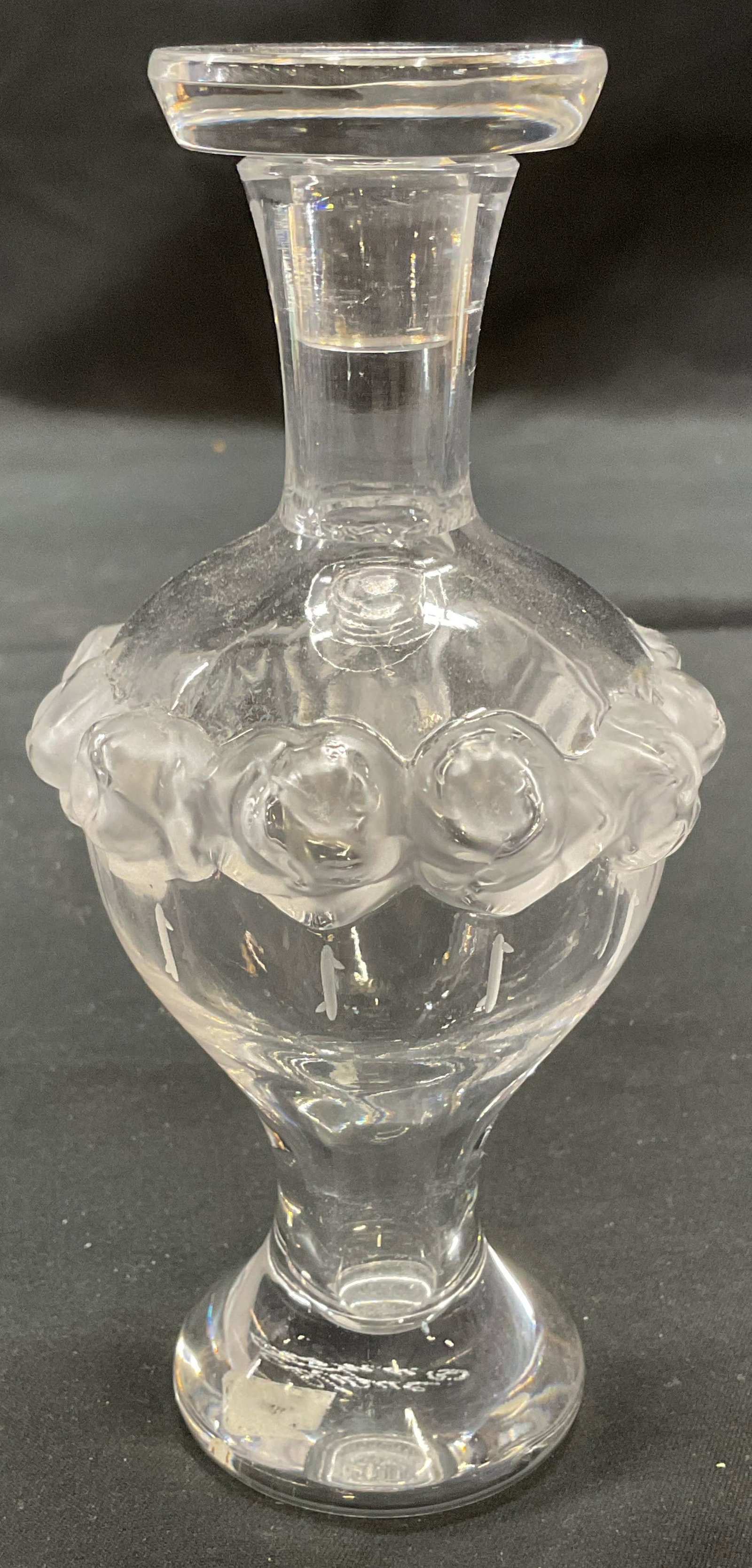 Lalique Martine Crystal Perfume Bottle, France: Lalique Martine Crystal perfume bottle. Raised frosted rosette motif and etched detail. Signed to underside. Made in France. Measures approx. 2.75 x 5.5 inches. Some surface wear including scratching 