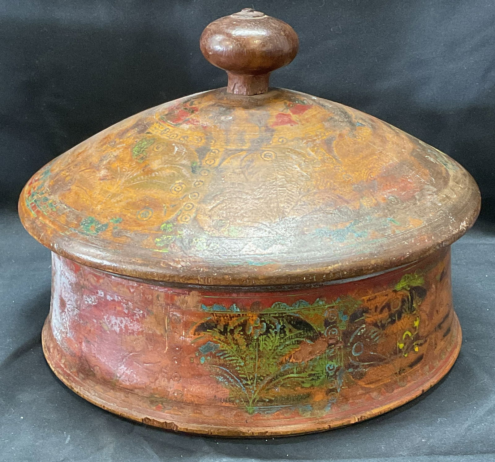 Antique Wooden Round Box with Lid: Antique wooden round shaped box with lid. Hand painted and carved detail with botanical motif. Measures approx. 9.25 x 7 inches. Surface wear including loss to paint and scratching observed. Wooden bo